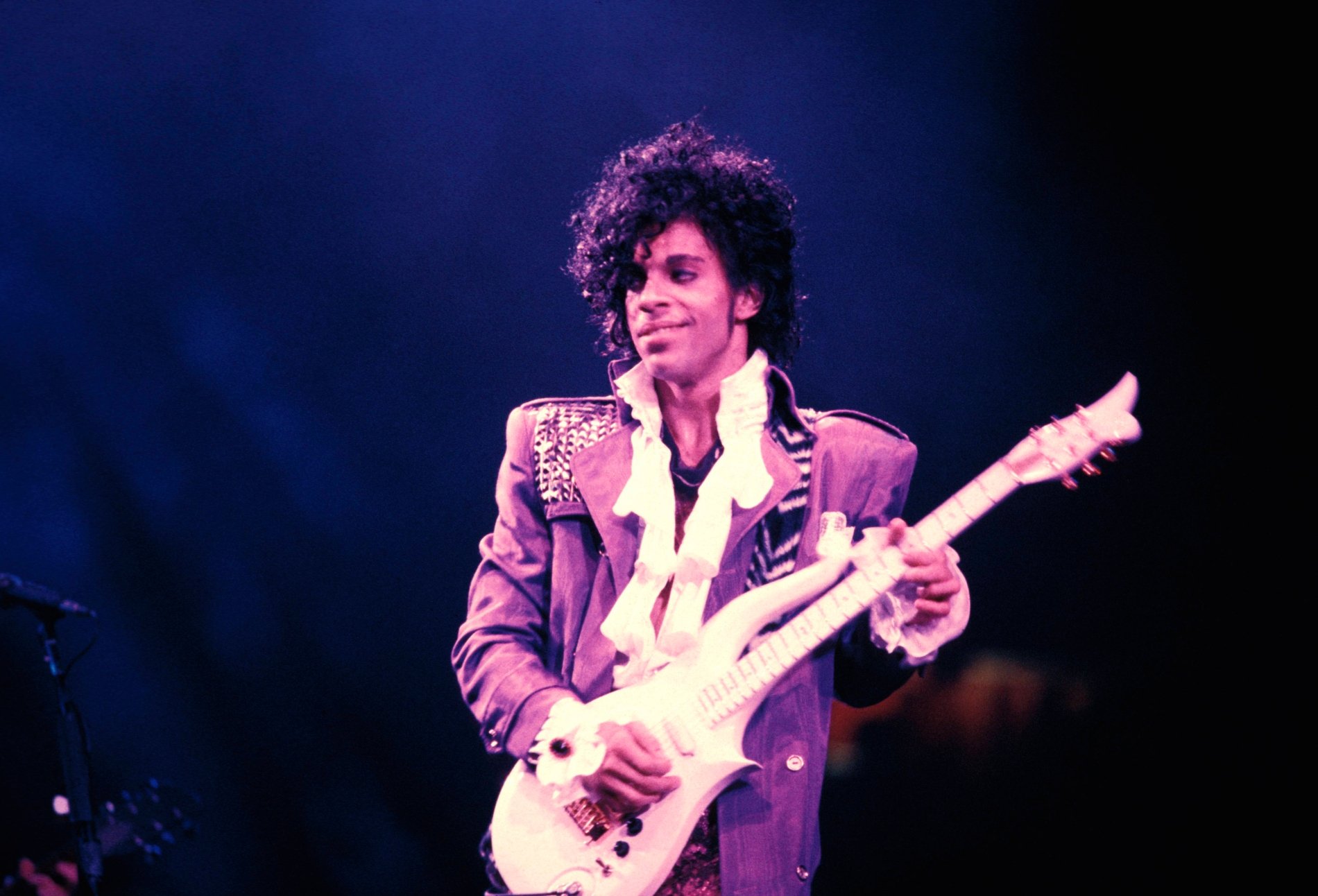 Prince performing with his guitar during 'Purple Rain' tour