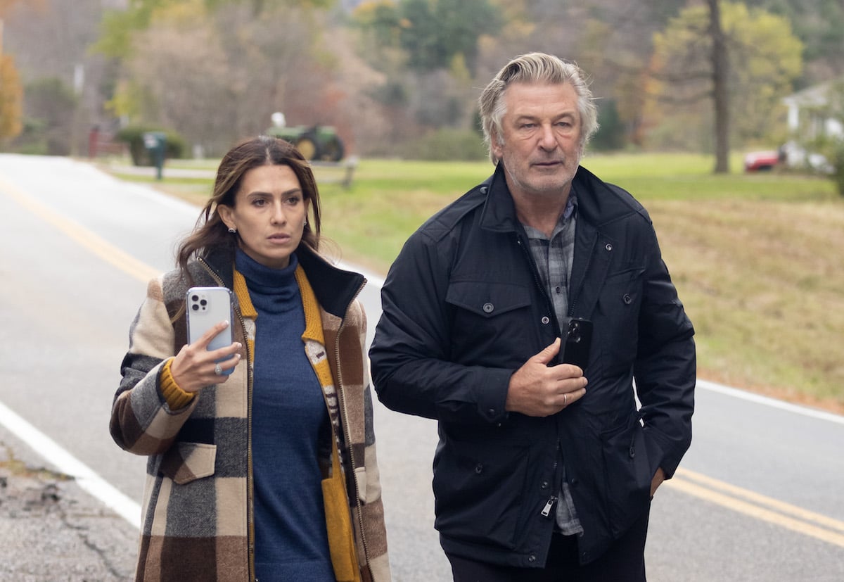 Alec and Hilaria Baldwin walking on a road