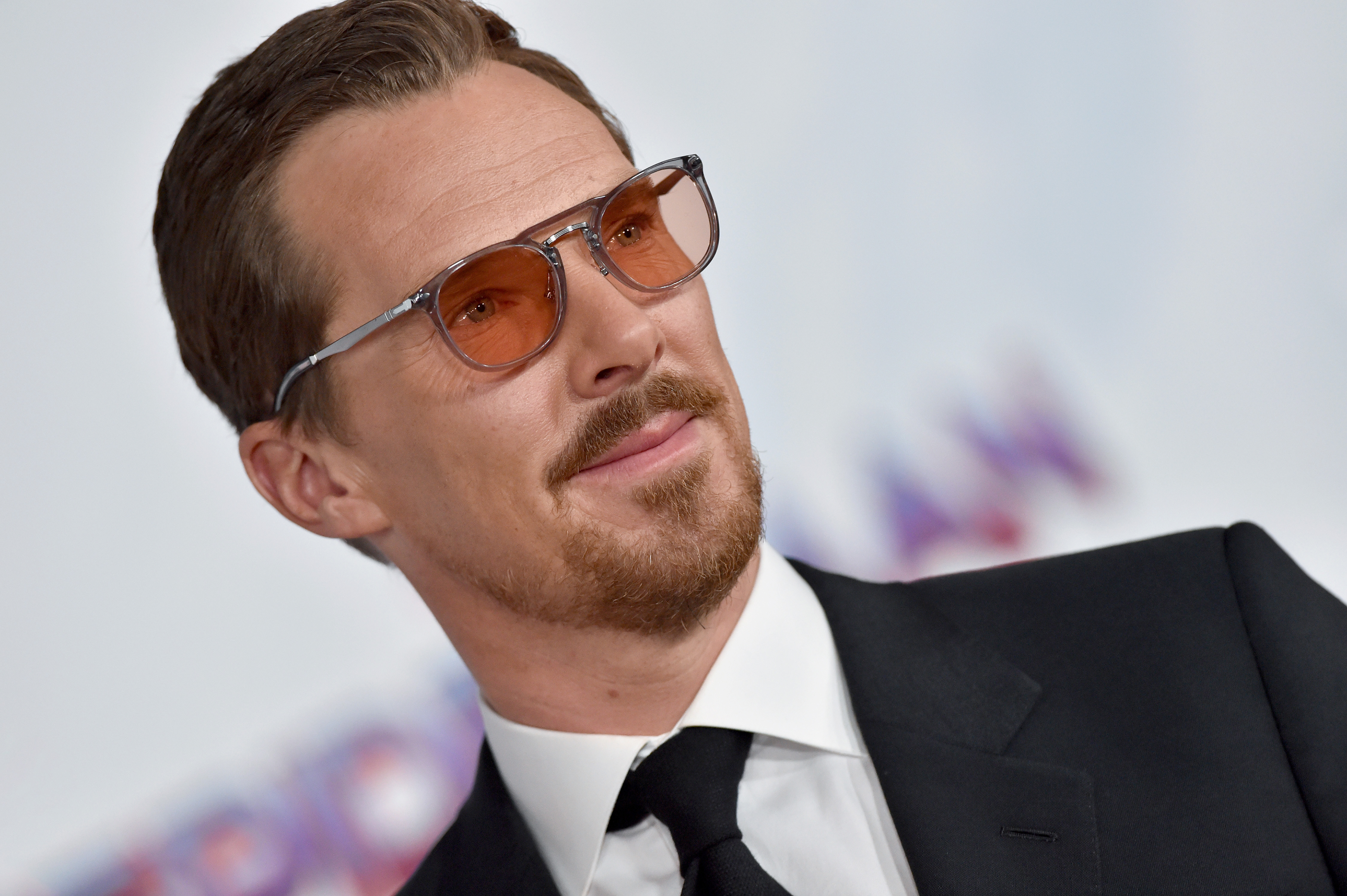 'Doctor Strange in the Multiverse of Madness' star Benedict Cumberbatch, who appears as both a hero and villain in the trailer, wears orange-tinted glasses and a black suit over a white-button up shirt and black tie.