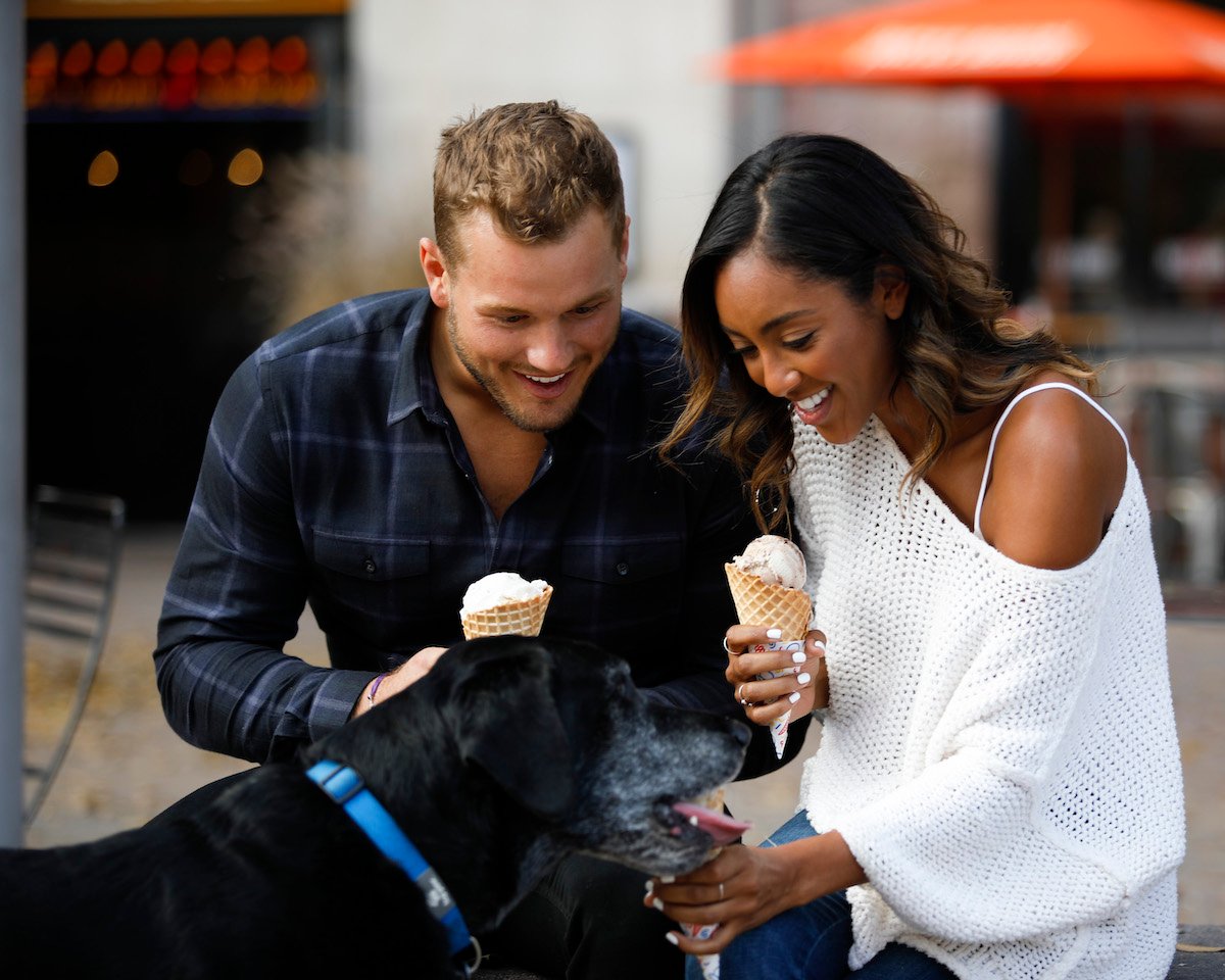 Colton Underwood and Tayshia Adams eat ice cream and pet a dog.