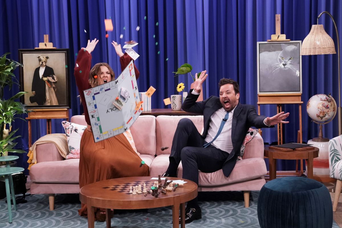 (l-r) Drew Barrymore flips a game board and host Jimmy Fallon reacts