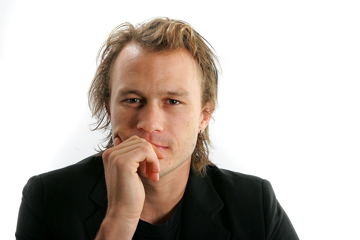 Heath Ledger posing in a black suit