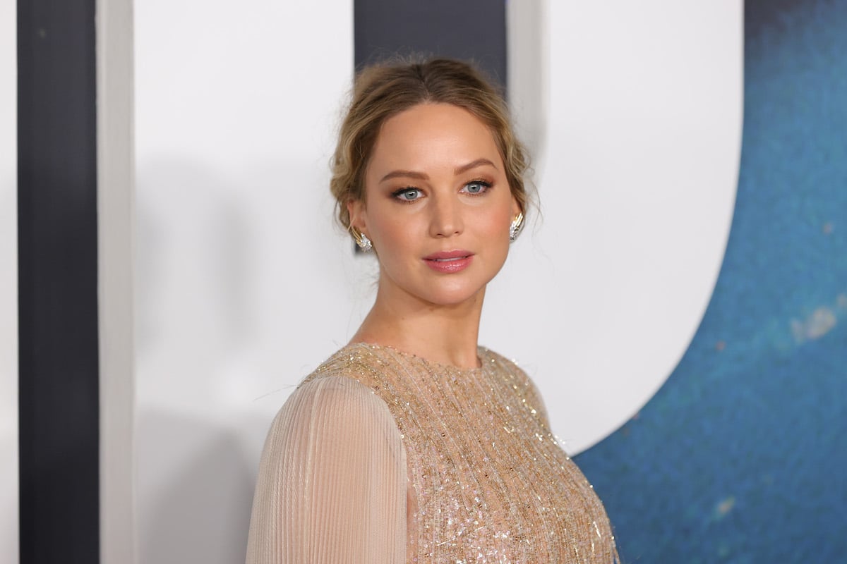 Jennifer Lawrence smiles for the camera at an event.