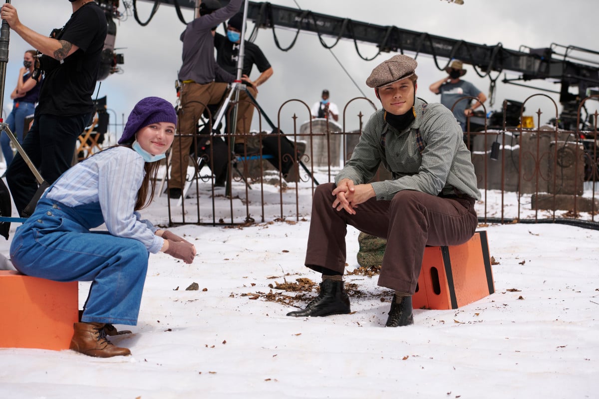 'The Waltons' Homecoming' cast members Marcelle LeBlanc and Logan Shroyer sit on boxes between takes