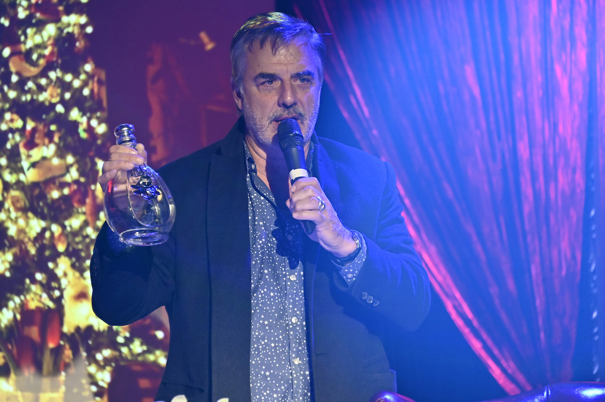 Chris Noth holds a bottle of tequila.