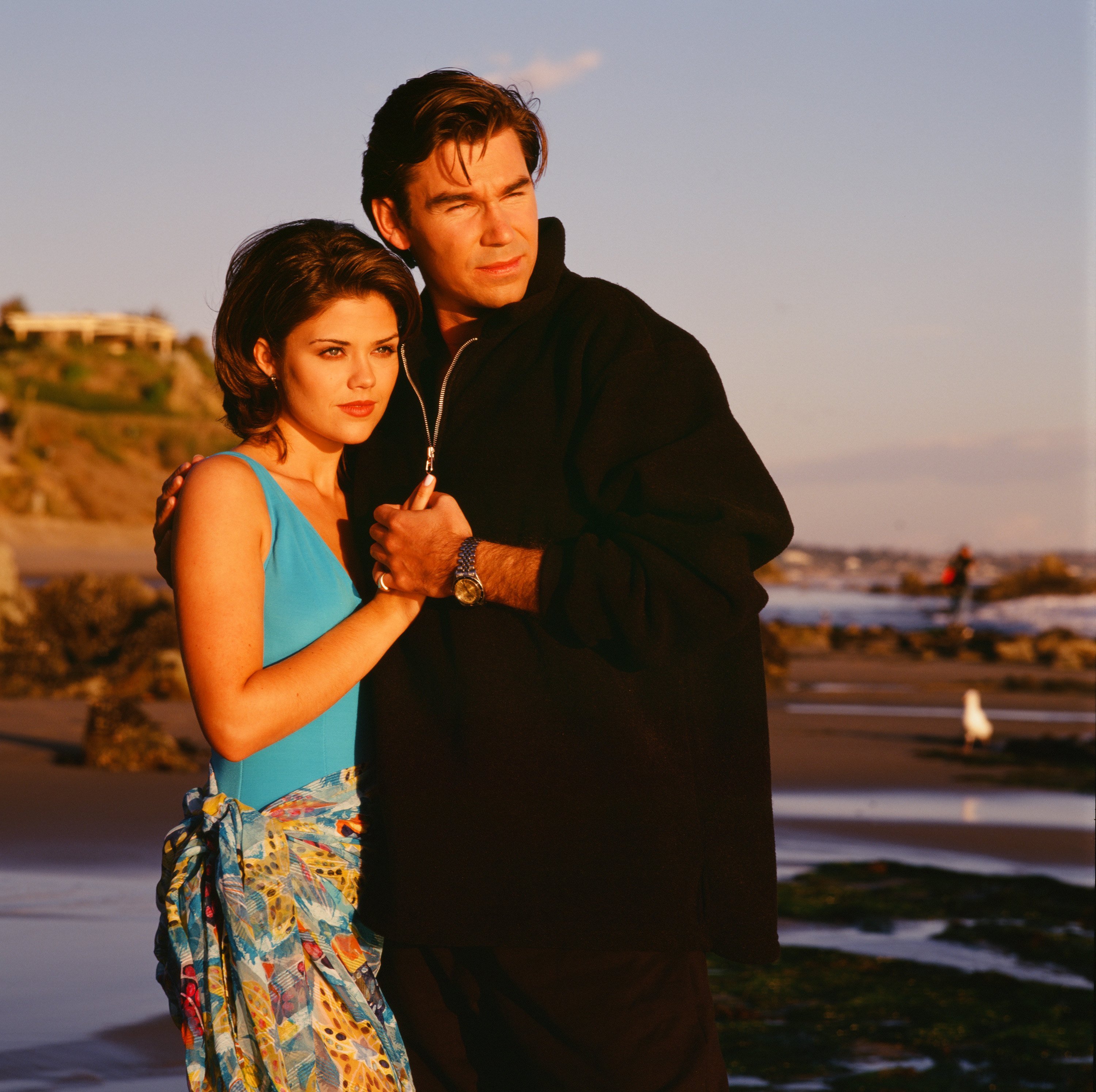 'Sunset Beach' actor Susan Ward in a blue print swimsuit, and Clive Robertson dressed in a black jacket.