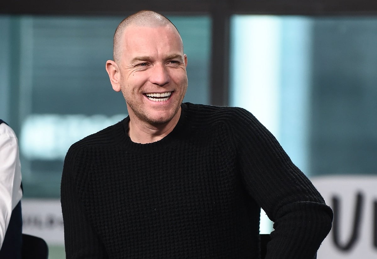 Ewan McGregor smiling in a black shirt.