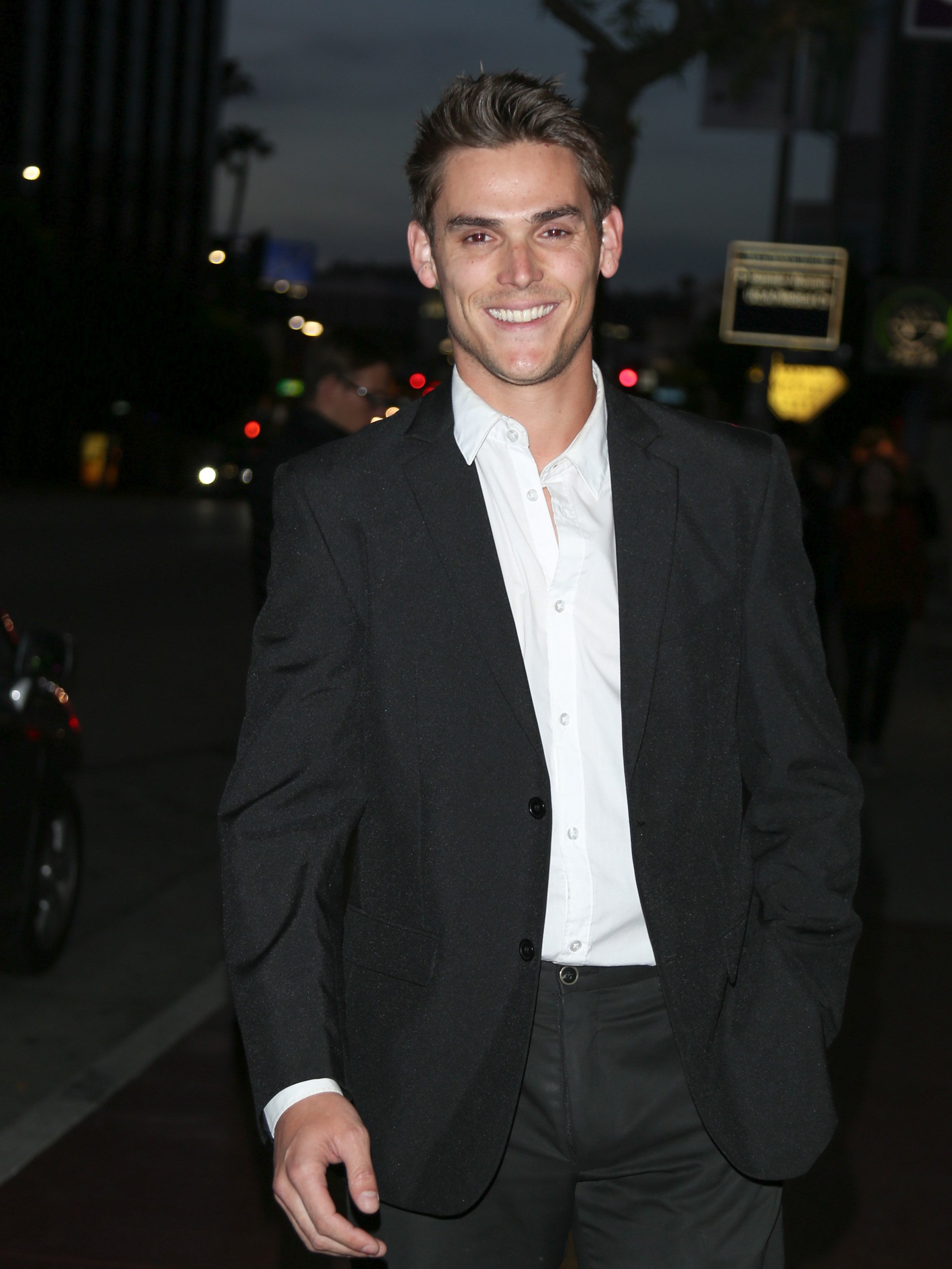 'The Young and the Restless' actor Mark Grossman wearing a black suit and white shirt during a red carpet appearance.