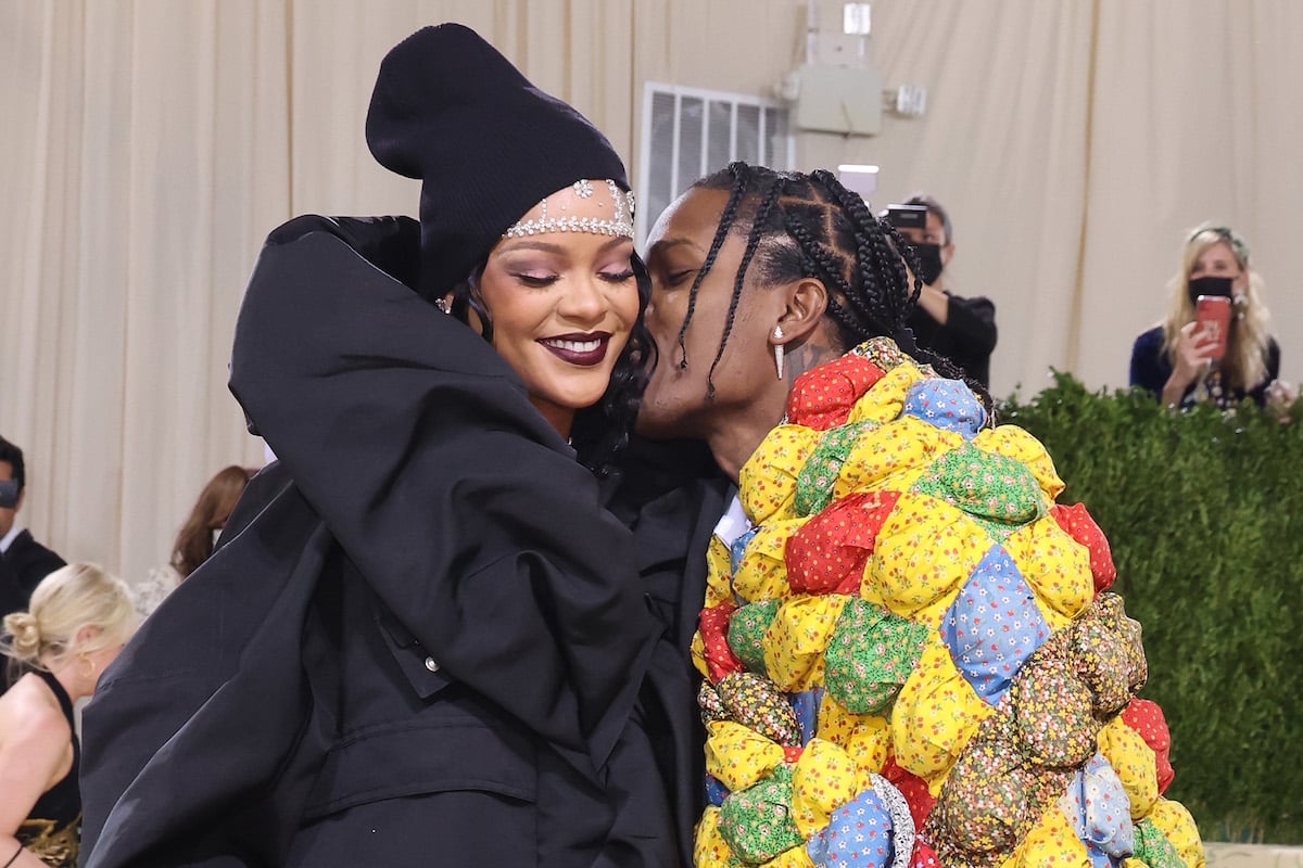 A$AP Rocky kisses Rihanna's cheek as she smiles at the 2021 Met Gala.