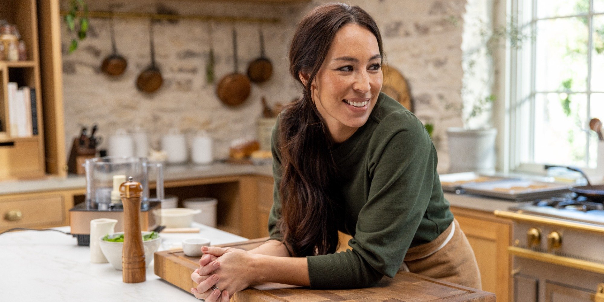 Joanna Gaines cooks in the kitchen of her discovery+ show.