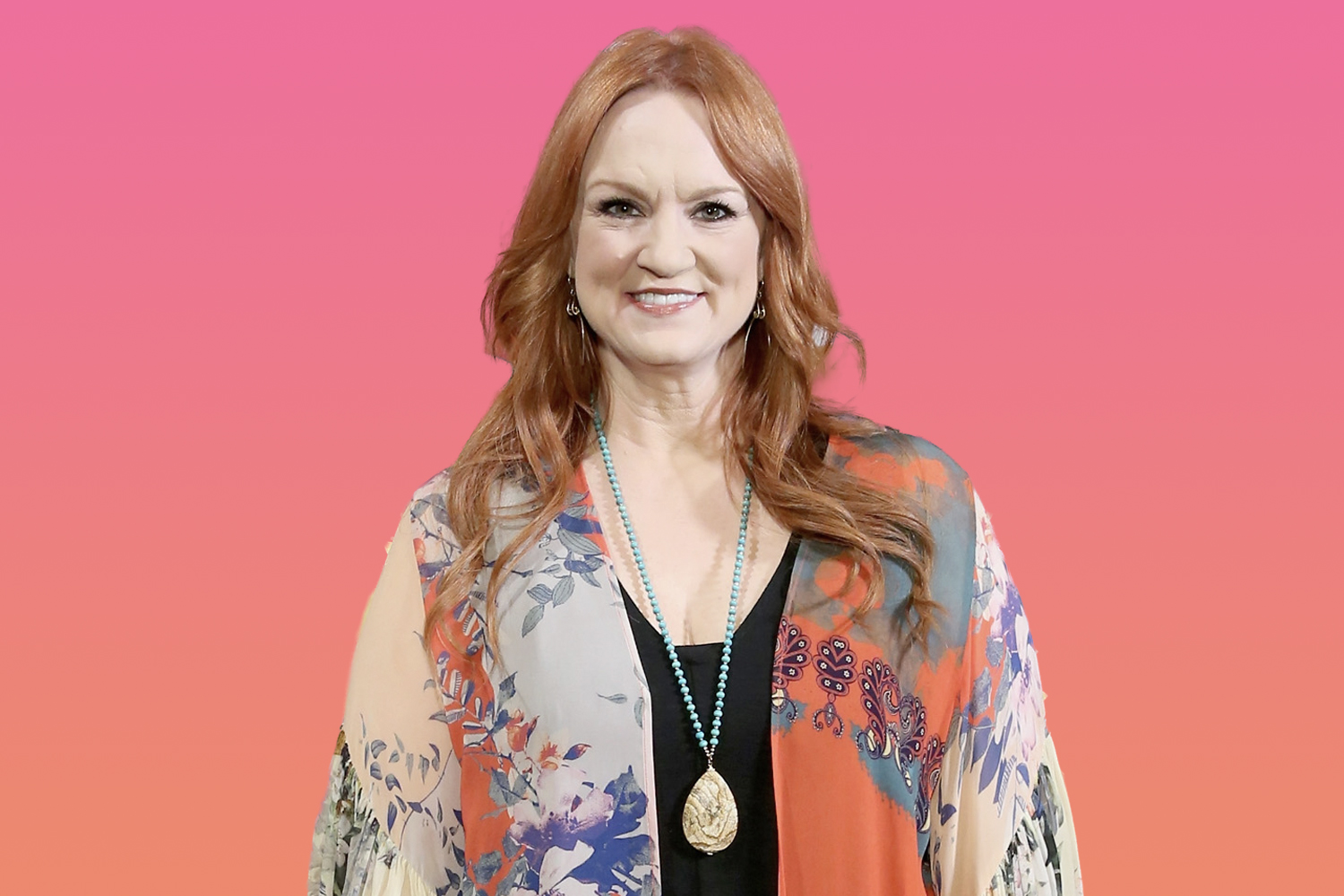 Ree Drummond smiling, wearing a medallion hanging from a turquiose necklace, and a sheer top with a black undershirt