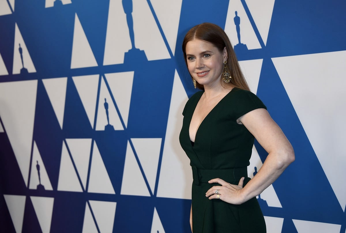 Amy Adams smiling while wearing a green dress.