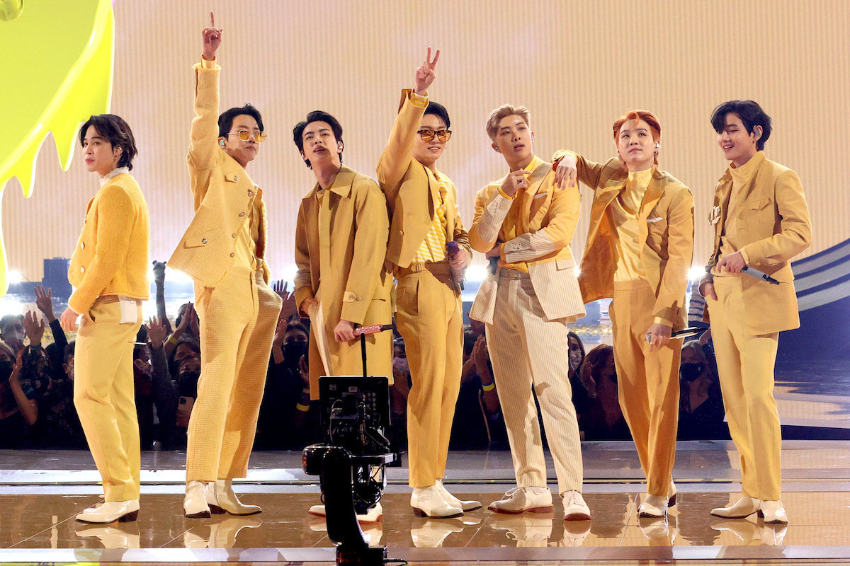 Jimin, J-Hope, Jin, Jungkook, RM, Suga, and V of BTS perform onstage at the 2021 American Music Awards