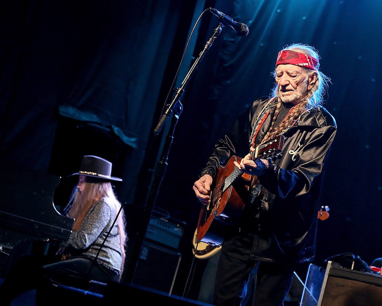 Bobbie Nelson sits at a piano while Willie Nelson plays guitar