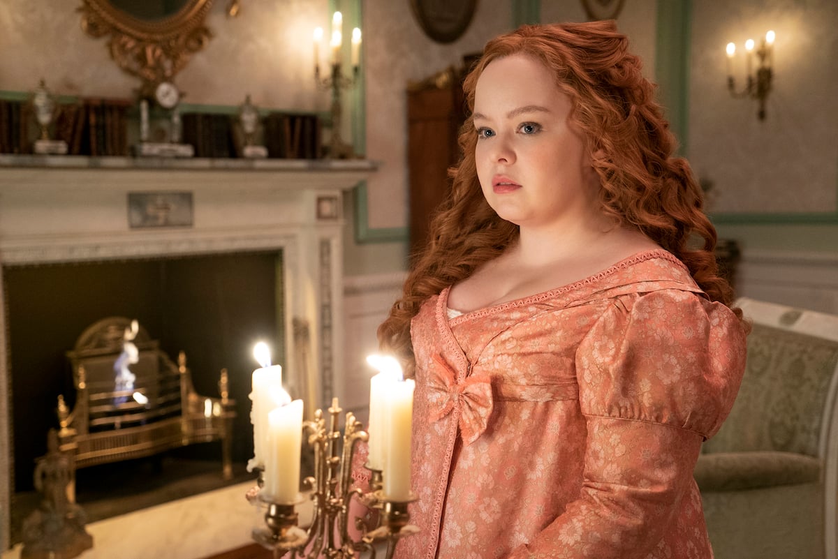 Nicola Coughlan as Penelope, wearing a pink dress and with her hair down, in 'Bridgerton' Season 2