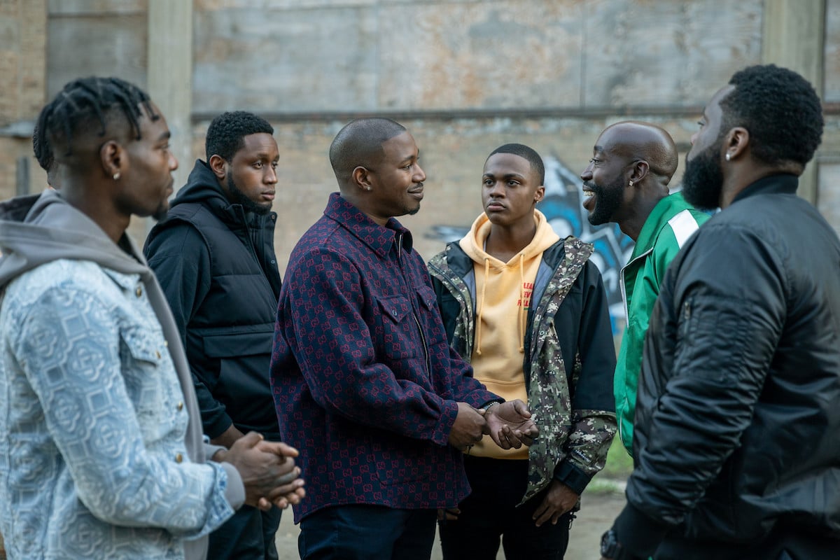 Kris D. Lofton as Jenard and Freddie Gibbs as Cousin Buddy conversing in a crowd in 'Power Book IV: Force' 