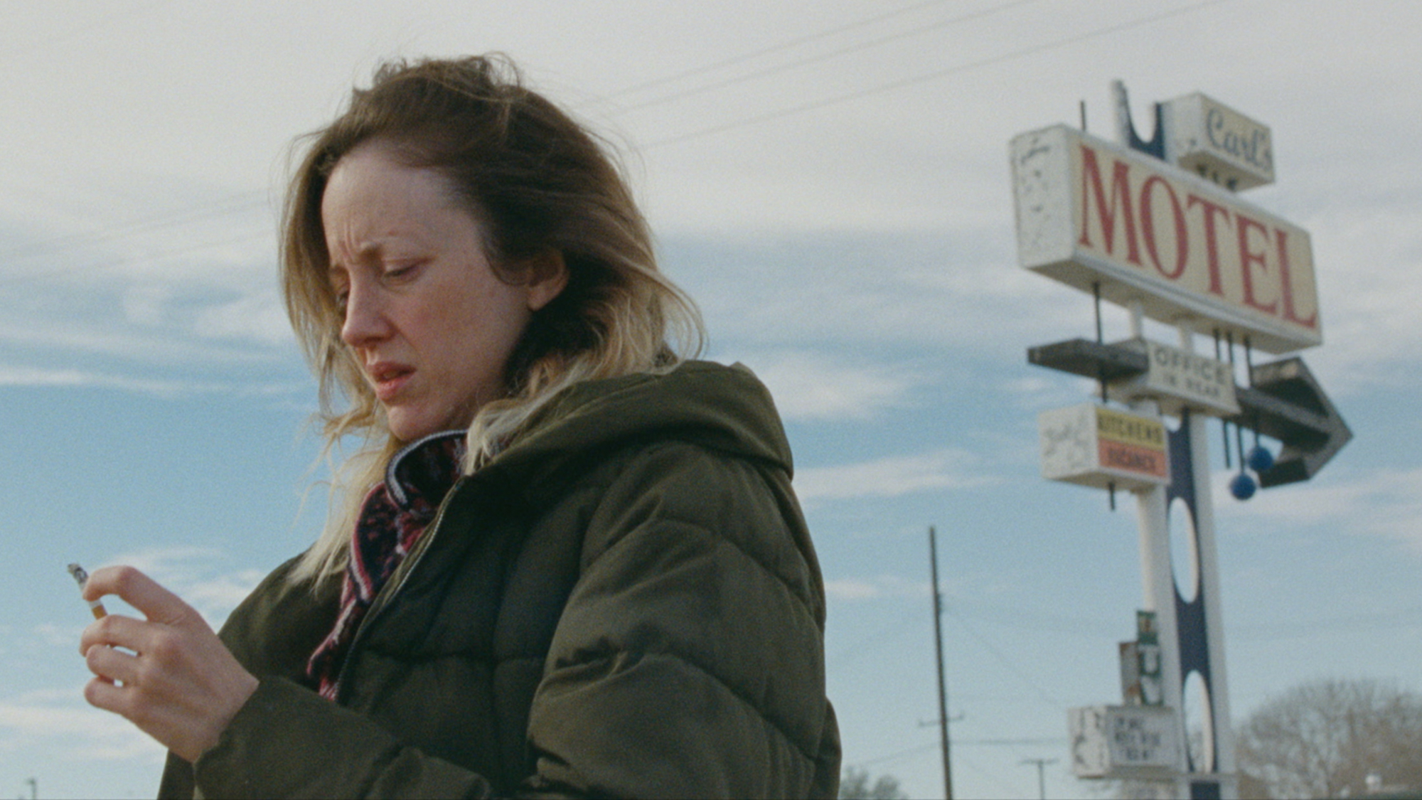 'To Leslie' Andrea Riseborough as Leslie (1) holding a cigarette with a motel sign behind her