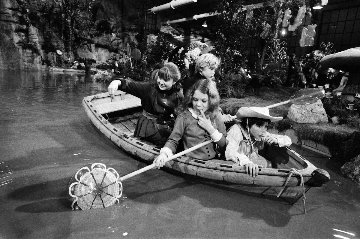 Sailing in the boat are Denise Nickerson, Peter Ostrum, Julie Dawn Cole and Paris Themmen (this is not the boat used in the film). They are using giant lollipops as paddles. 8th October 1970.