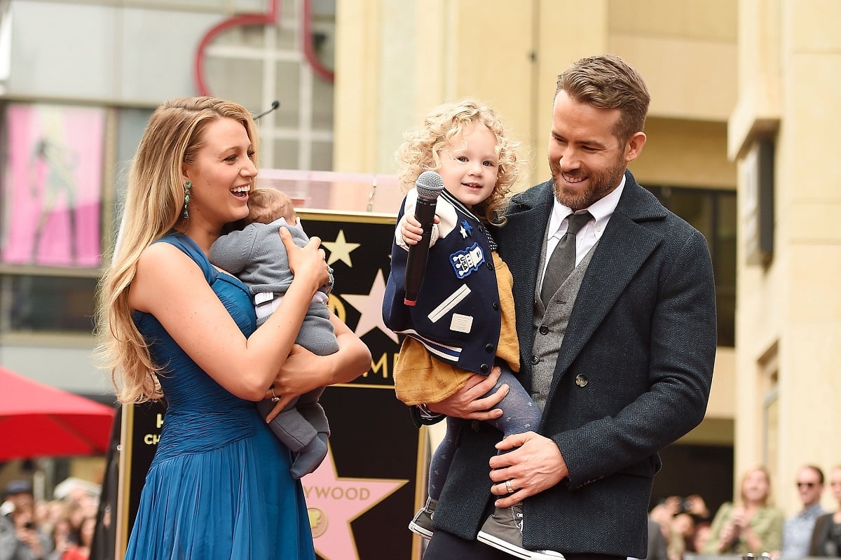 Blake Lively (L) and Ryan Reynolds (R) hold their kids, Inez and James (C)