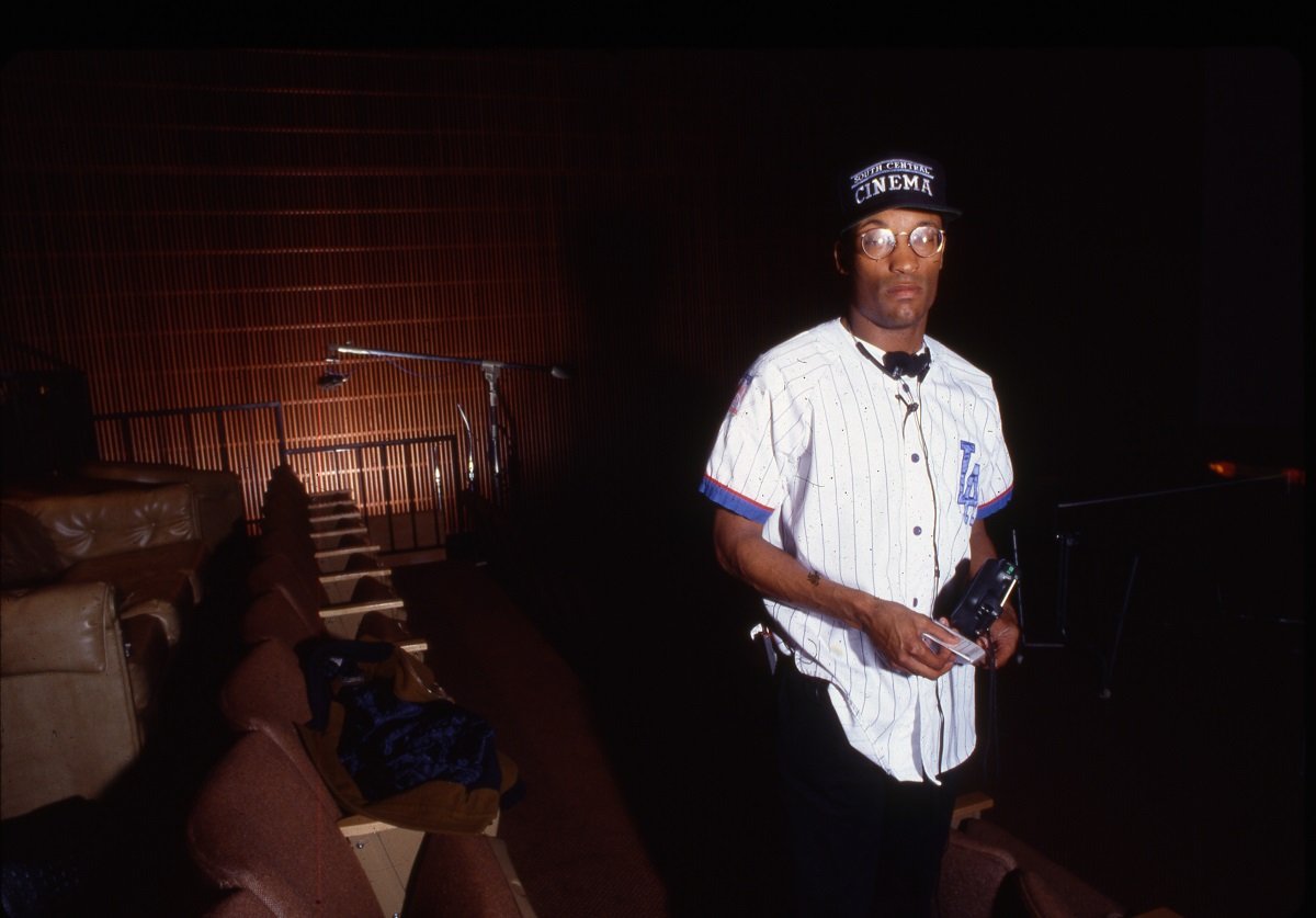 John Singleton, who planned to make a Tupac biopic, posing while wearing a buttoned white shirt.