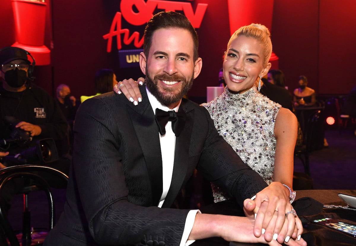 Tarek El Moussa and Heather Rae Young pose together at an event.