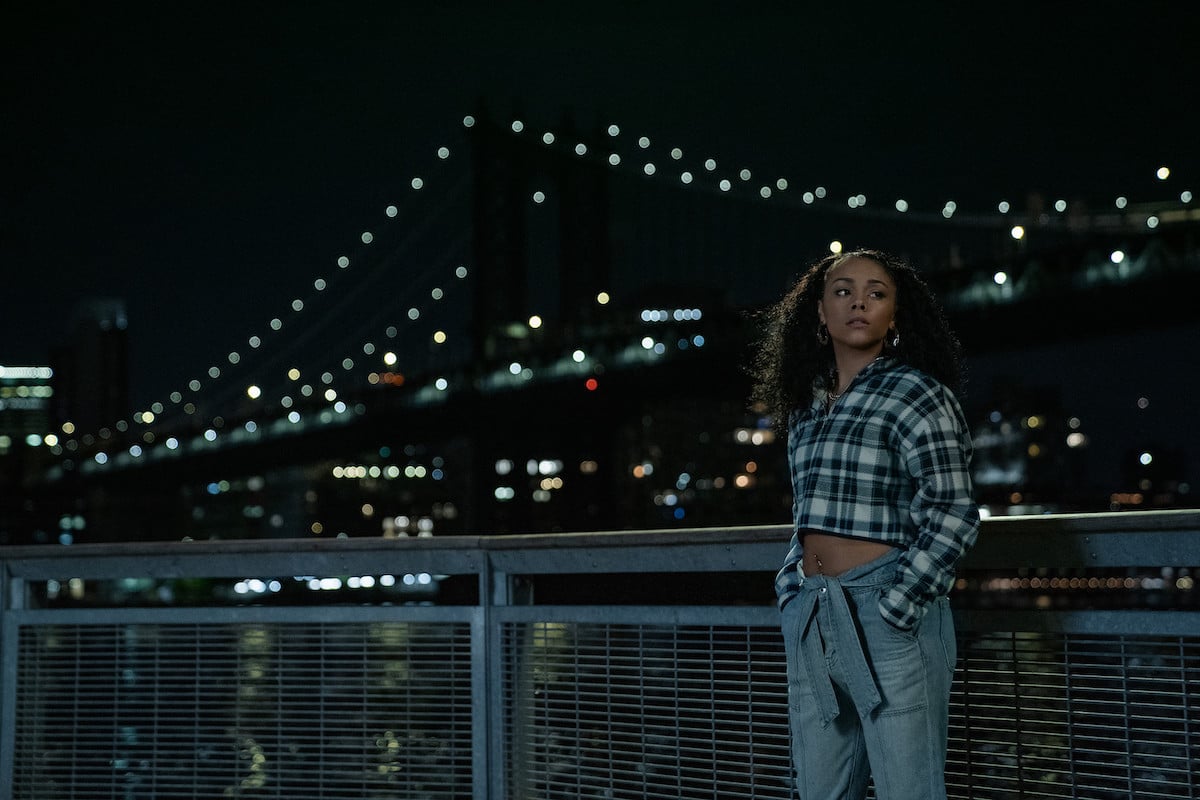 Alix Lapri as Effie Moralas standing at a dock with a NYC bridge in the background in 'Power Book II: Ghost'