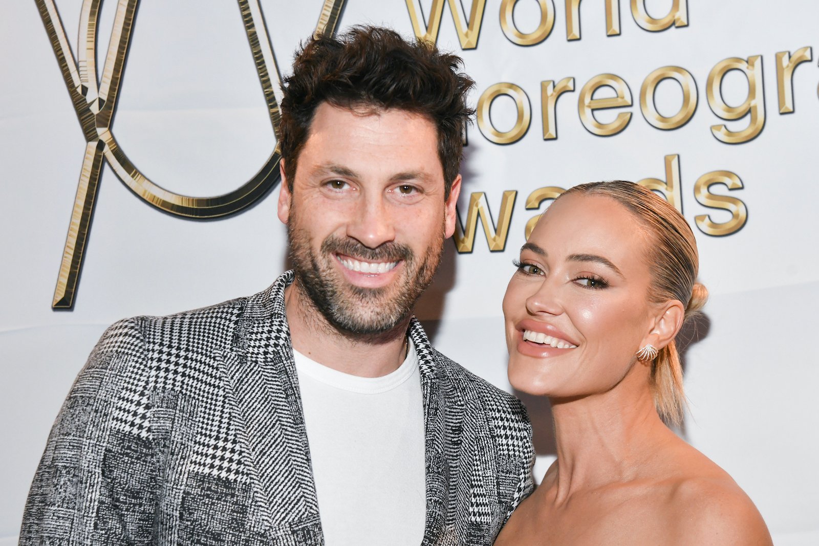 Maksim Chmerkovskiy and Peta Murgatroyd smile during a red carpet event in Dec. 2021