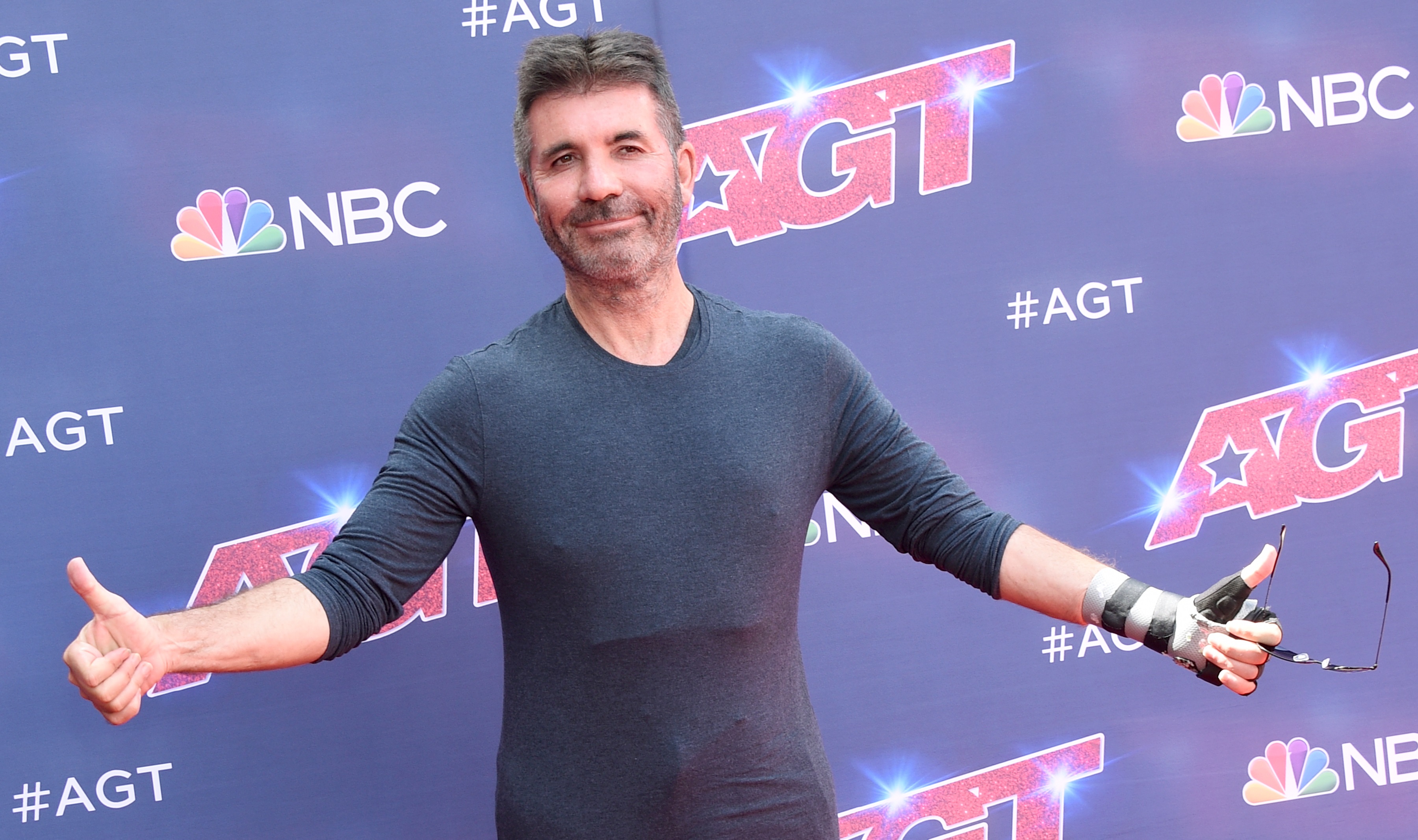 'America's Got Talent' judge Simon Cowell with his arms out posing for the season 17 kick-off