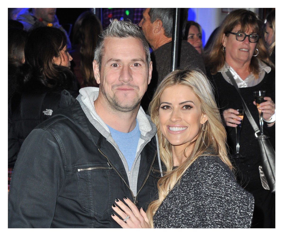 Ant Anstead and Christina Haack smile and pose together at an event.