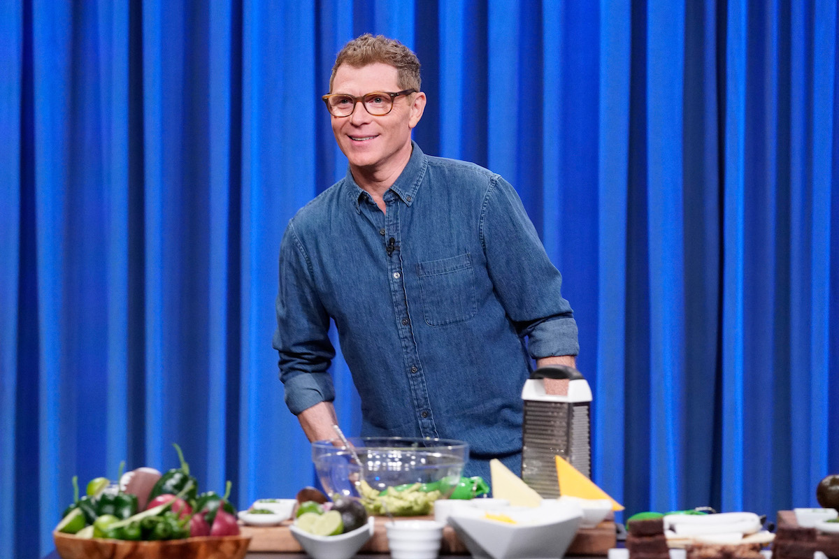 Bobby Flay, who says the key to grilled potato salad is a grill basket, smiles as he looks on