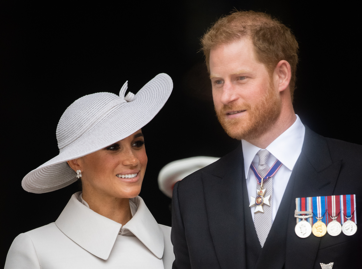 Meghan Markle and Prince Harry, who introduced Lilibet to Queen Elizabeth during Platinum Jubilee weekend, smile as they stand outside St. Paul's Cathedral