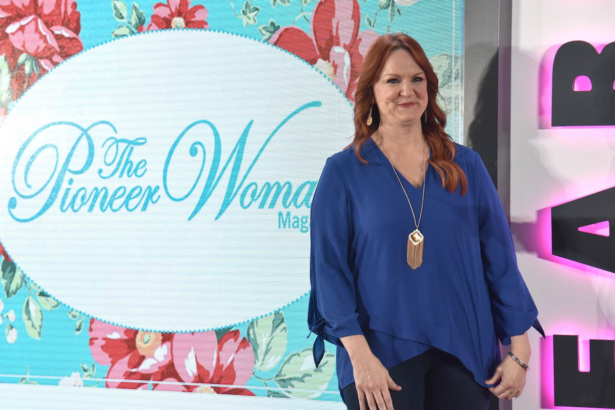 Ree Drummond, who has a pea salad recipe, smiles and looks on wearing a blue shirt