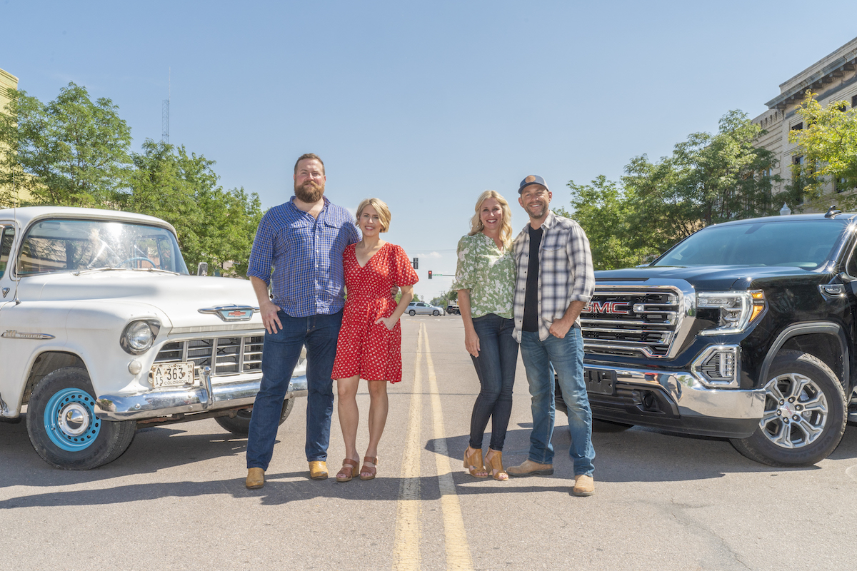 Ben and Erin Napier and Jenny and Dave Marrs from 'Home Town Takeover' Season 2 standing in front of pickup trucks