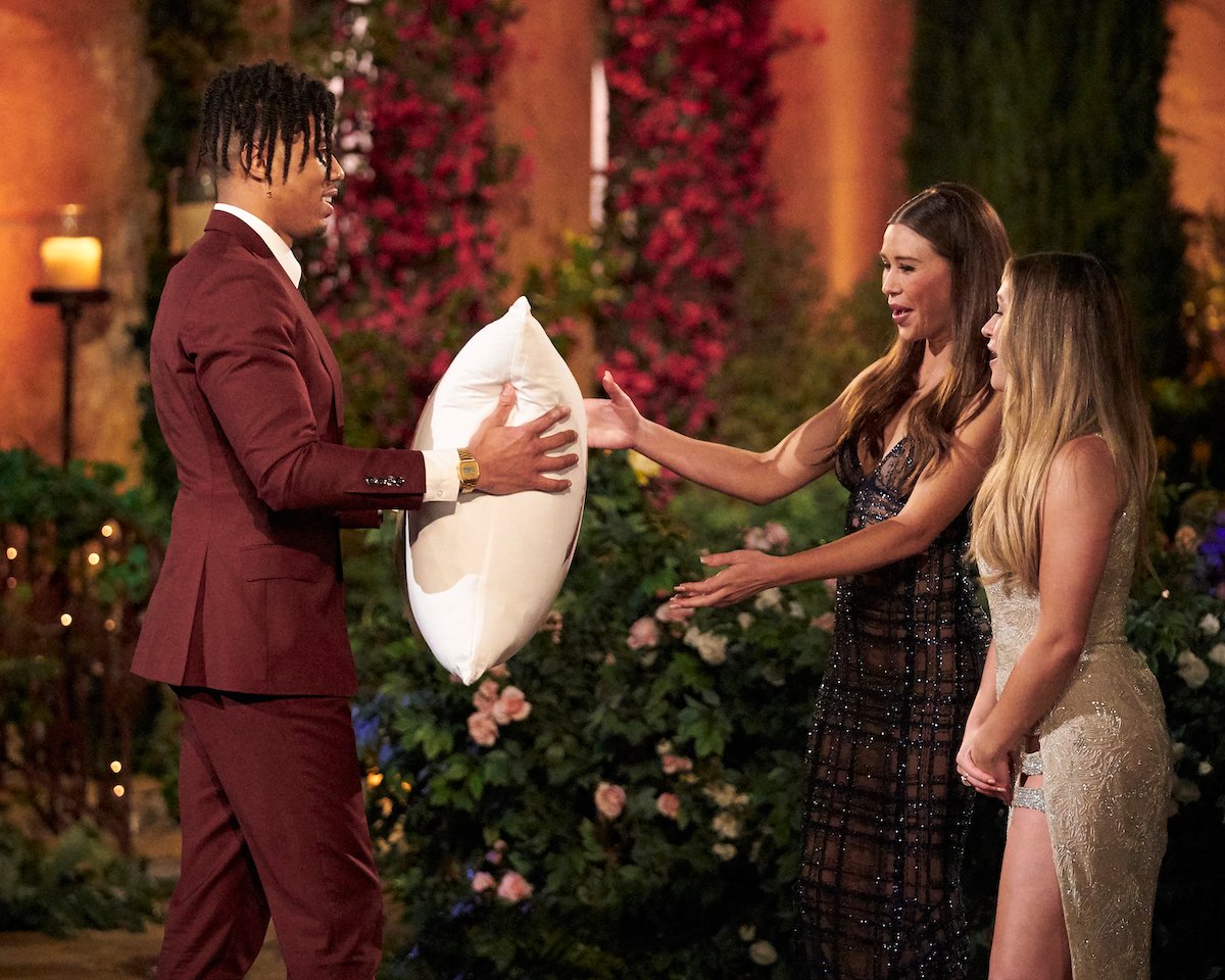 Nate Mitchell handing Gabby Windey and Rachel Recchia a pillow on night one of 'The Bachelorette' 2022.