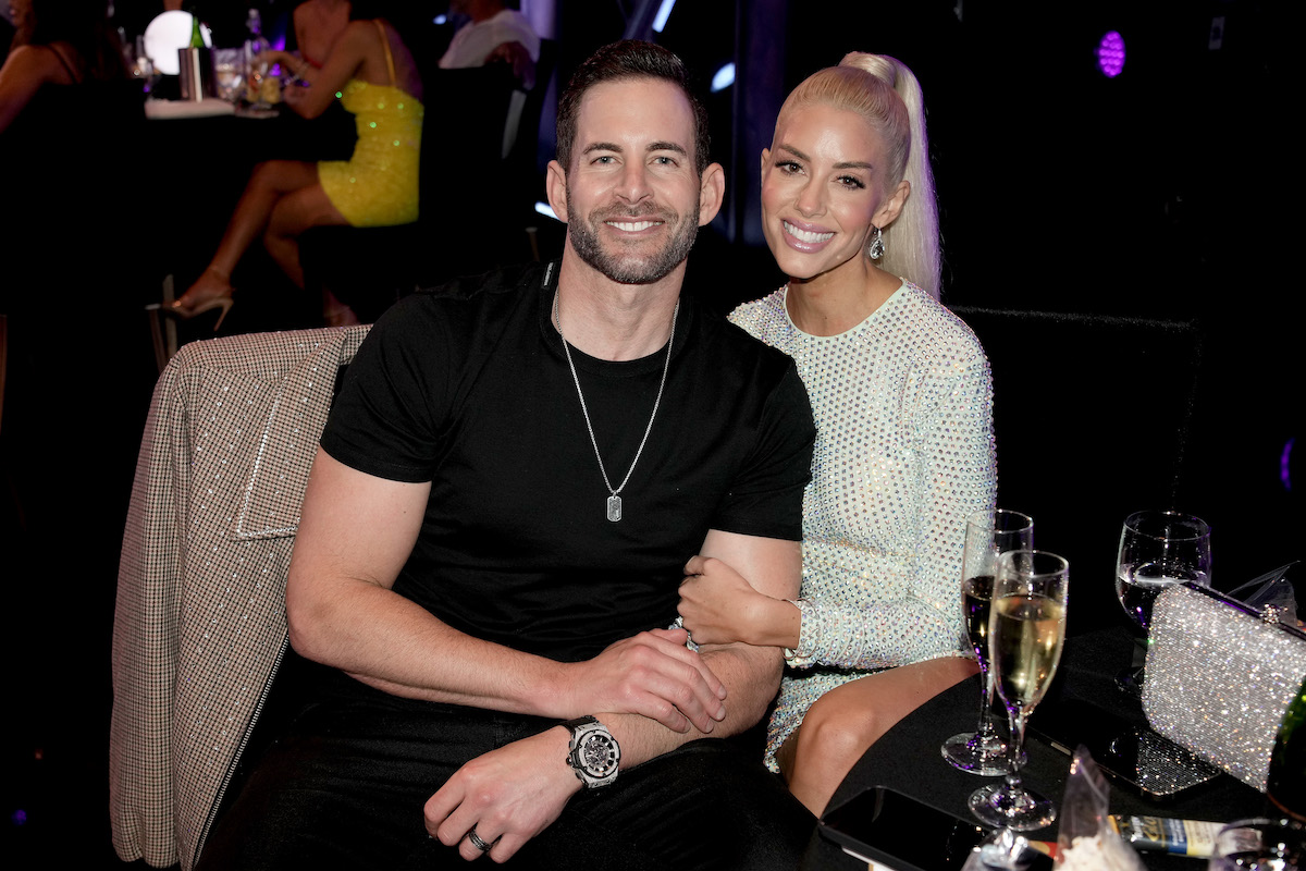 Tarek El Moussa and Heather Rae Young, who are having their first baby together, pose at an event.