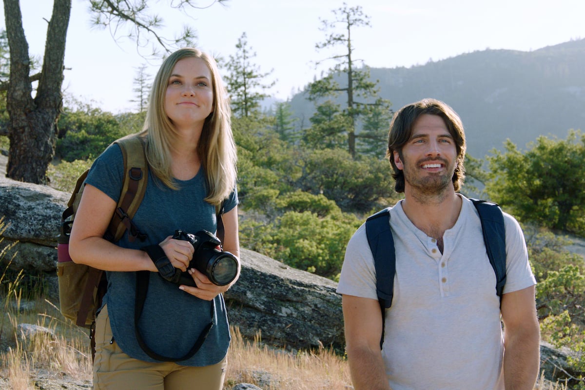 Cindy Busby, holding a camera, standing next to Tyler Harlow in the Hallmark movie 'Marry Me in Yosemite'