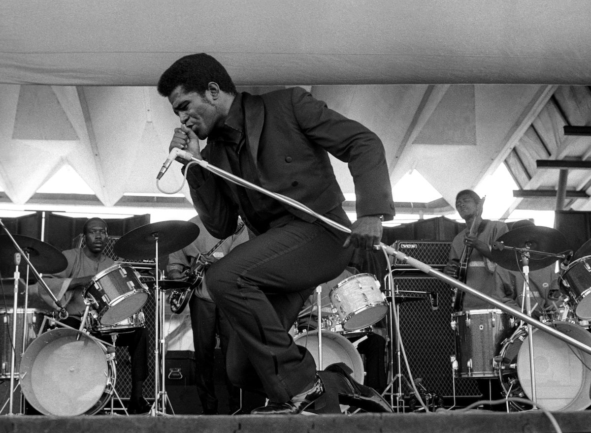 James Brown performing onstage, in black and white