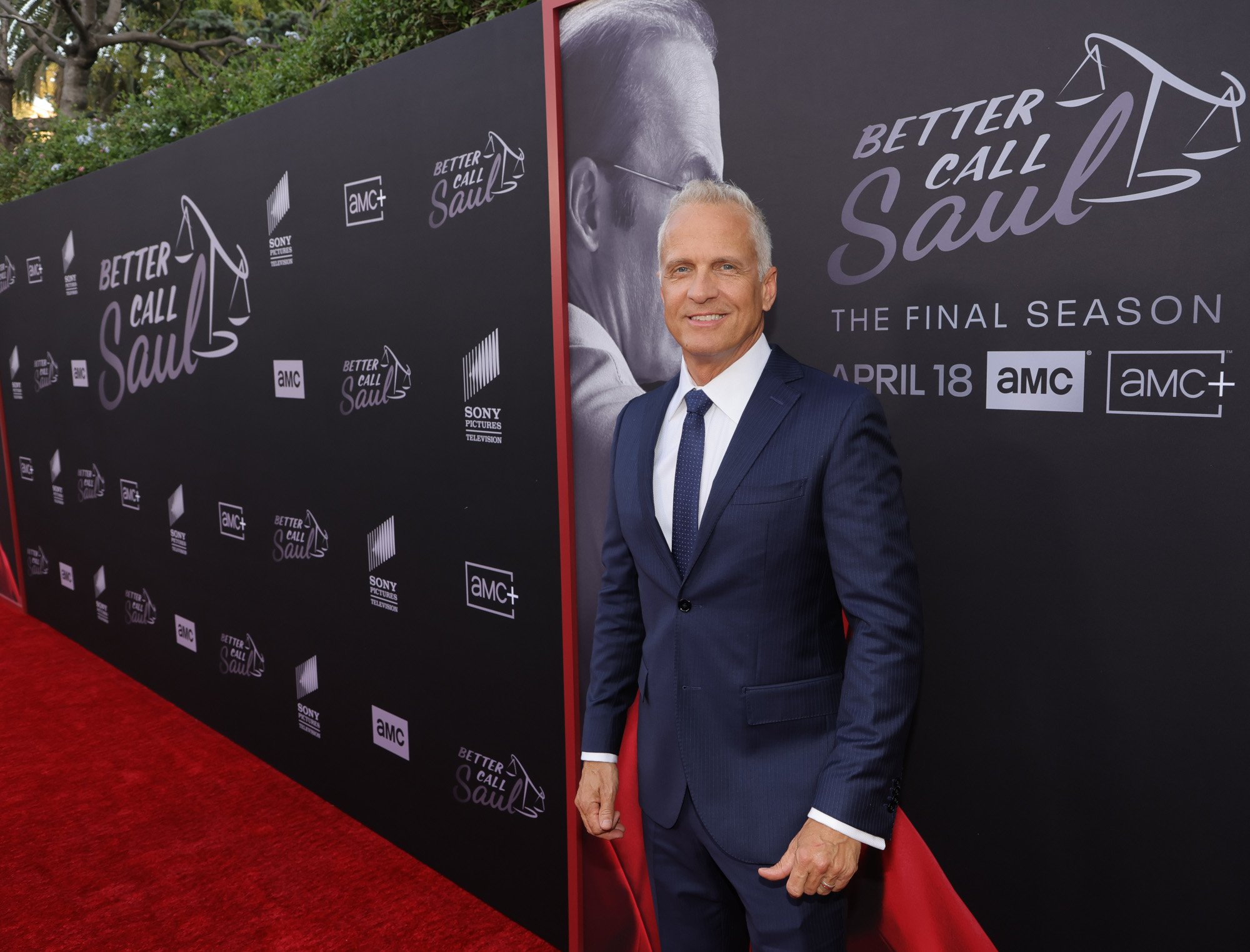 'Better Call Saul' star Patrick Fabian at the season 6 premiere. He's wearing a dark blue suit and smiling while standing on the red carpet.