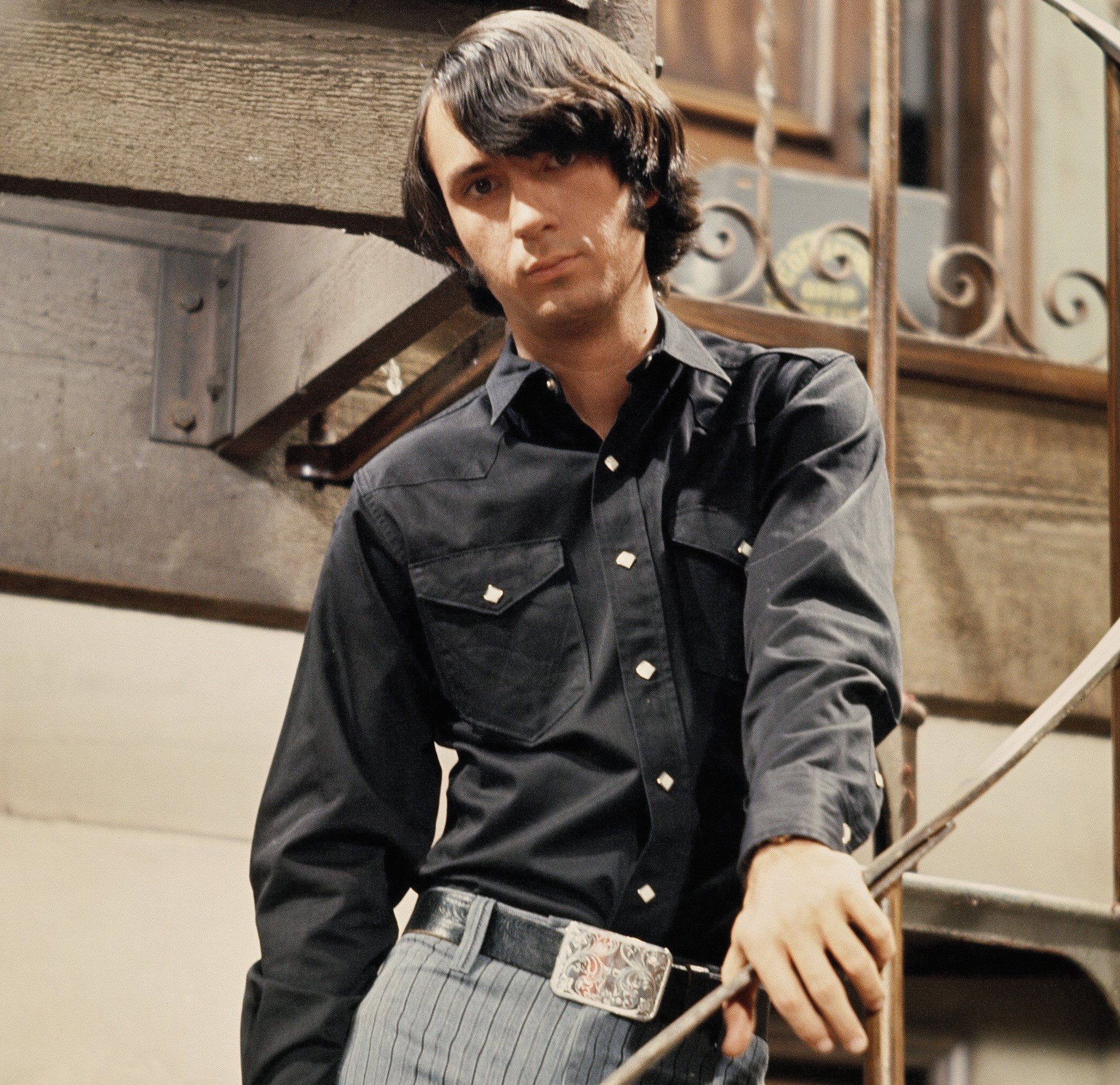 The Monkees' Mike Nesmith holding a railing