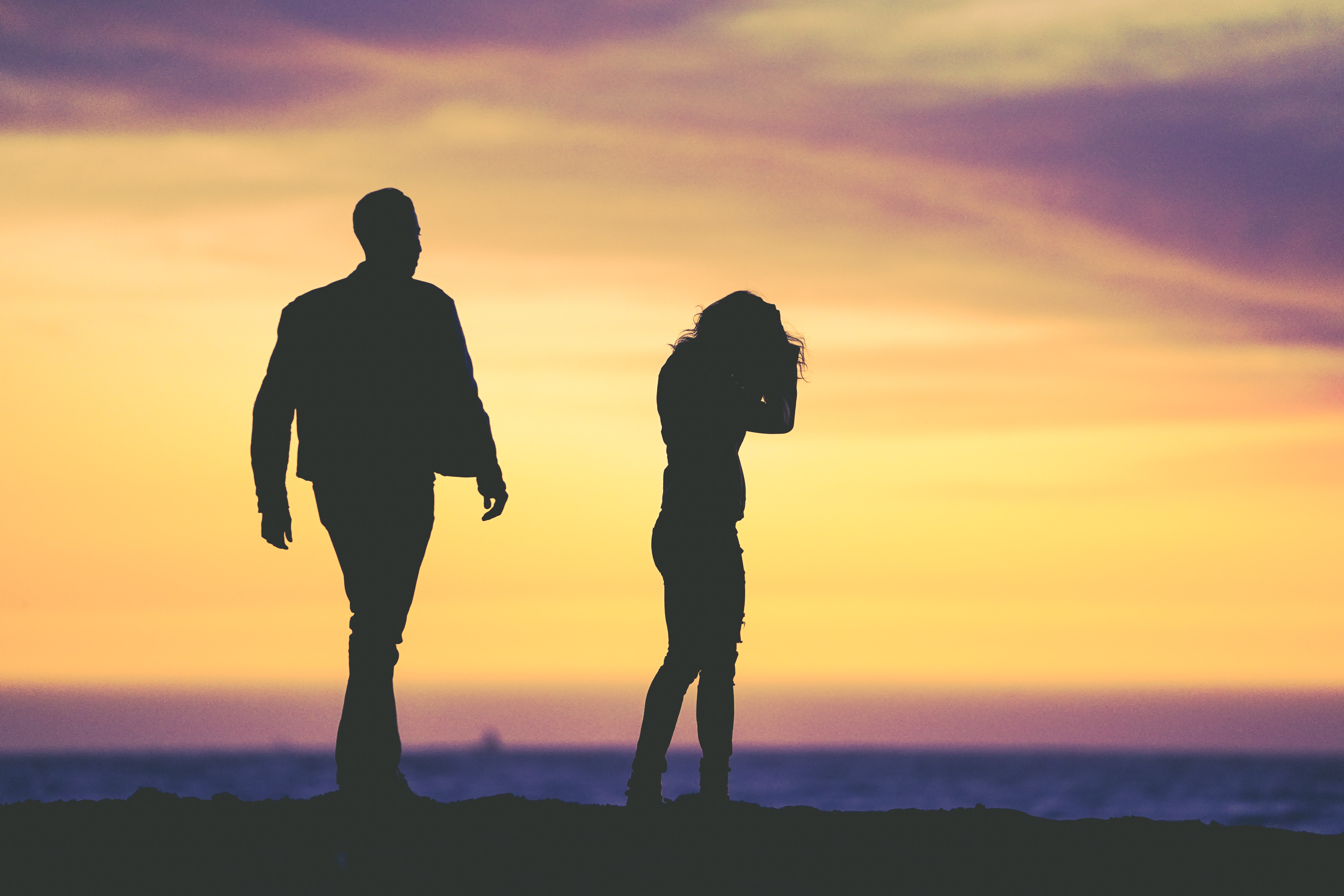 Couple arguing on the beach.