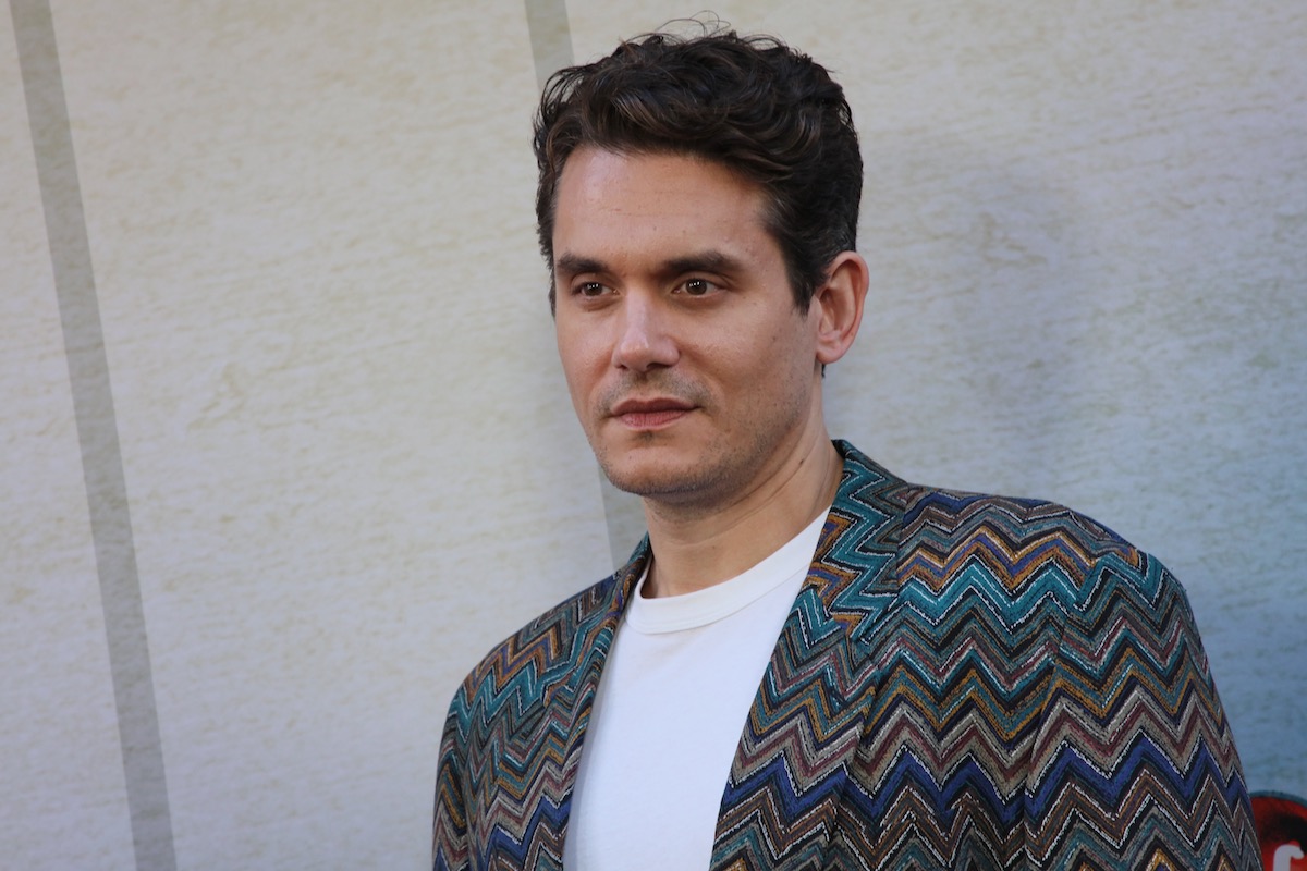 John Mayer in a colorful zigzag jacket with a white T-shirt underneath