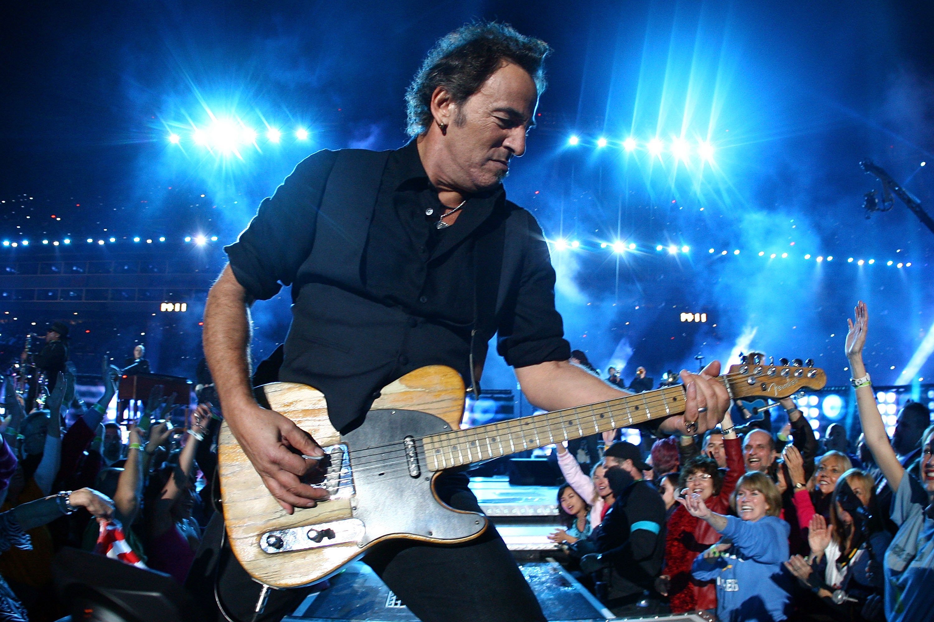 Bruce Springsteen plays his guitar at the Super Bowl.