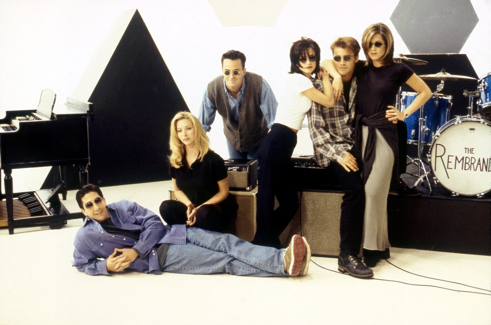 The 1994 cast of the hit show 'Friends' pose wearing sunglasses in front of band equipment.