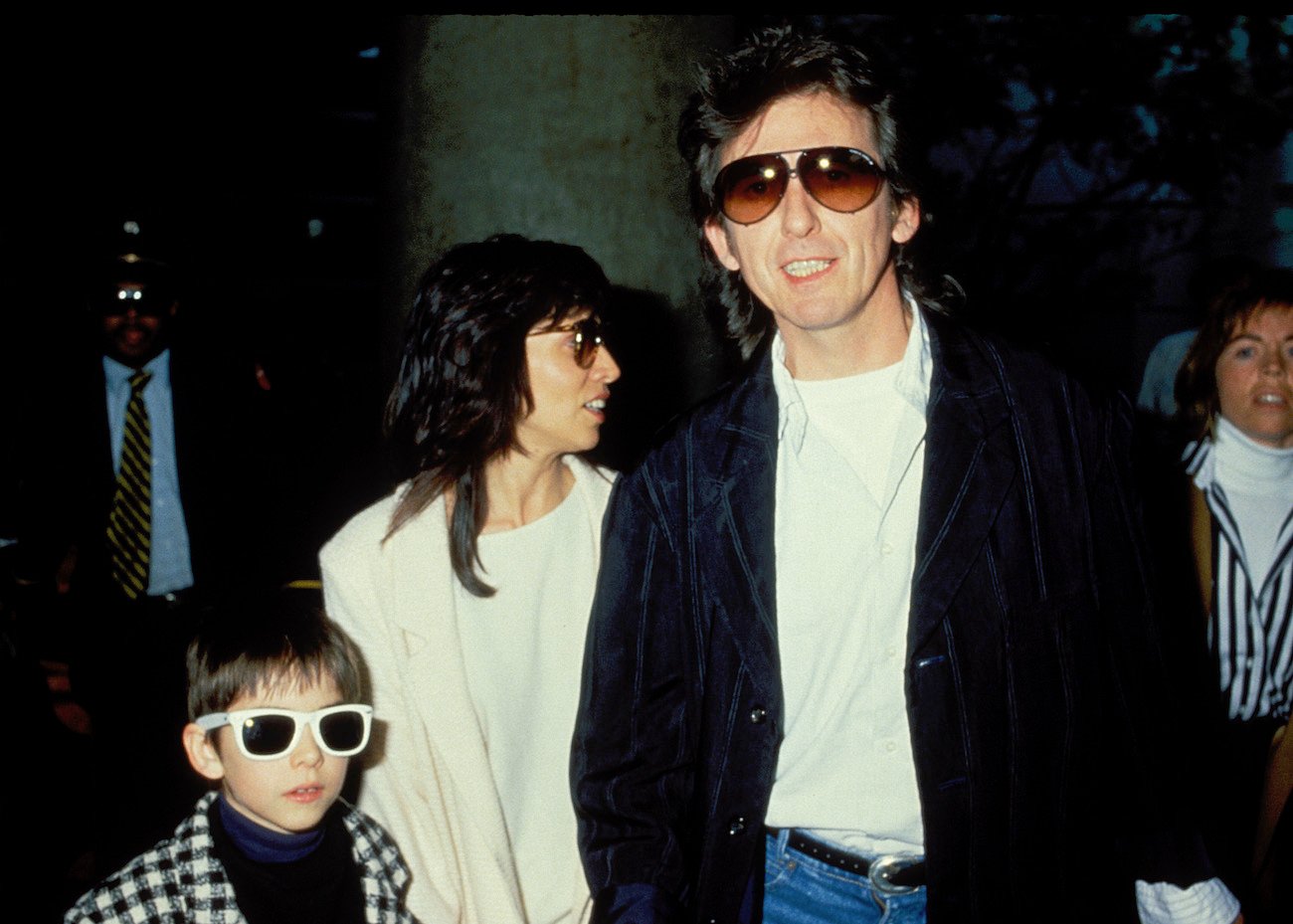 George Harrison with his wife, and their son at the airport in 1988.