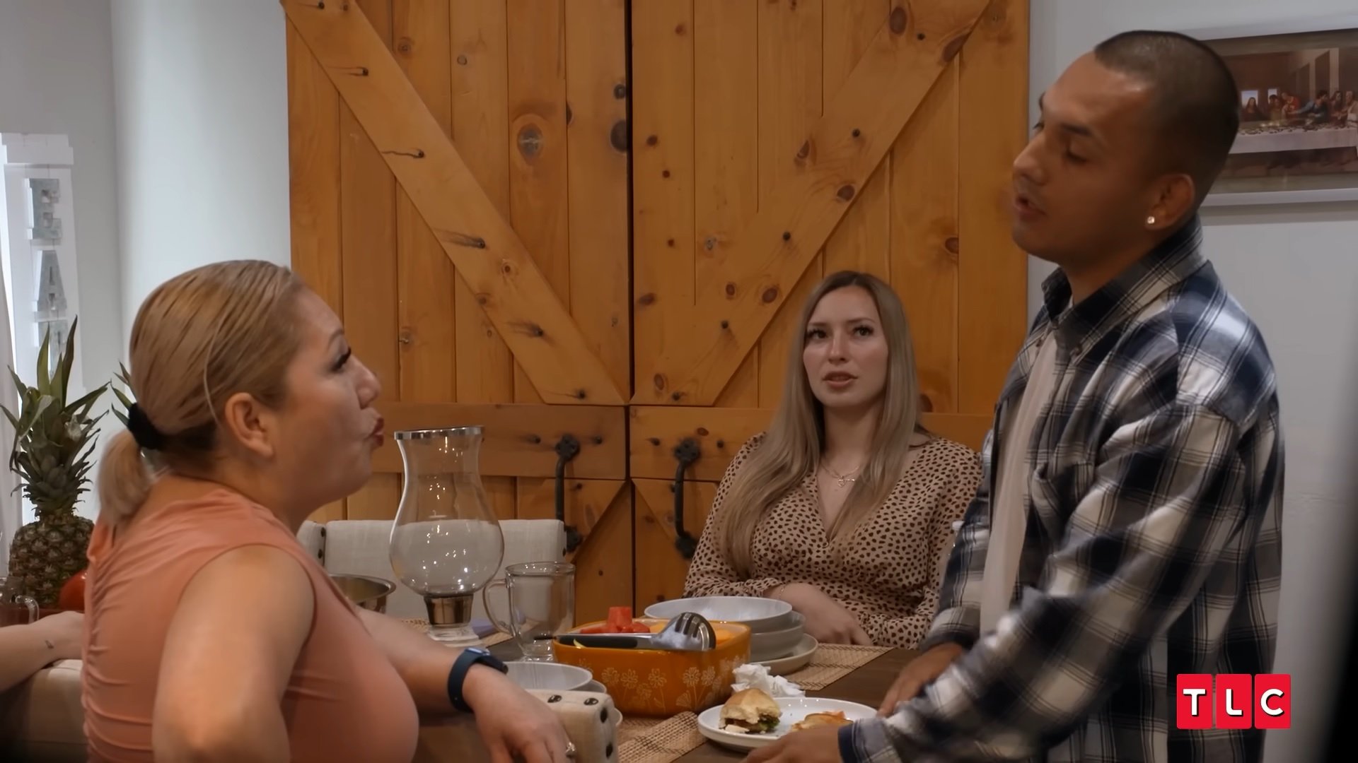 Nancy, Kristy, and Robert talk around a table on 'I Love a Mama's Boy.'