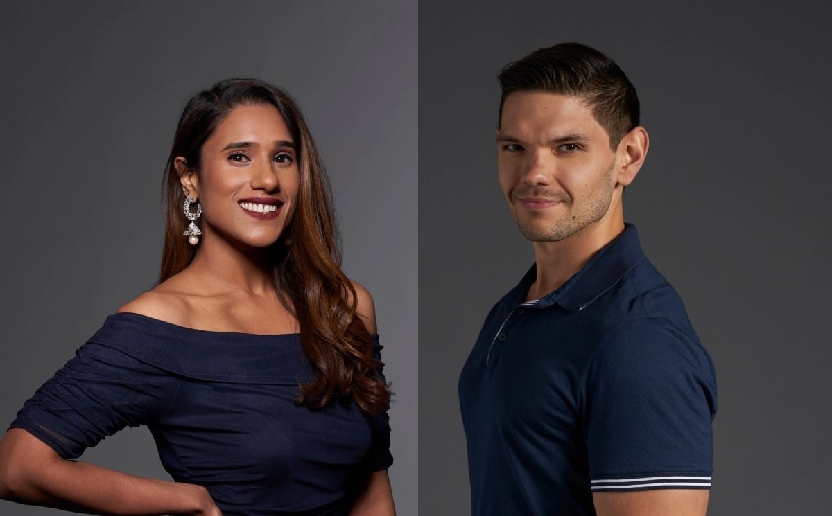 'Love Is Blind' stars Deepti and Kyle, both wearing navy blue in front of a gray background.