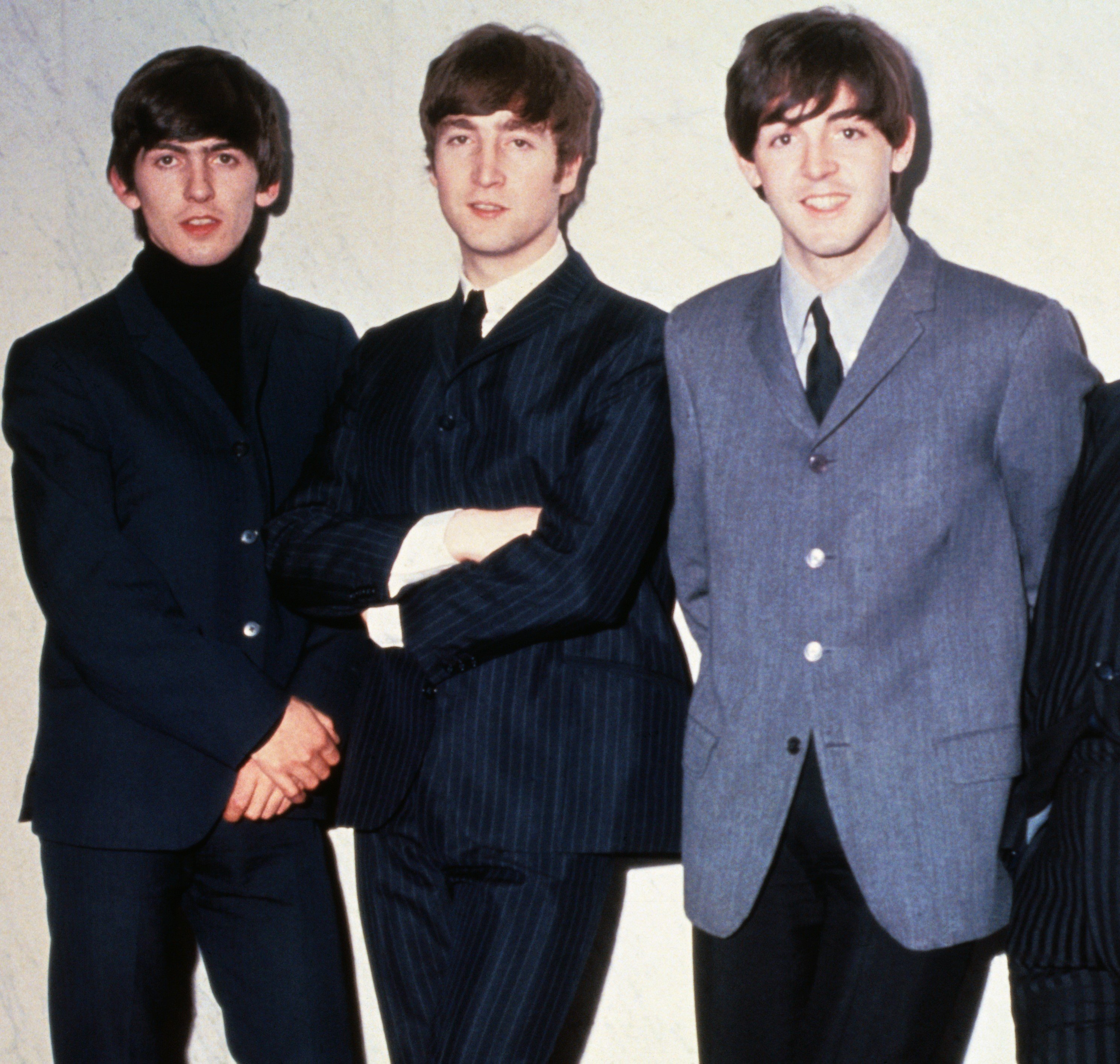 The Beatles' George Harrison, John Lennon, and Paul McCartney wearing suits