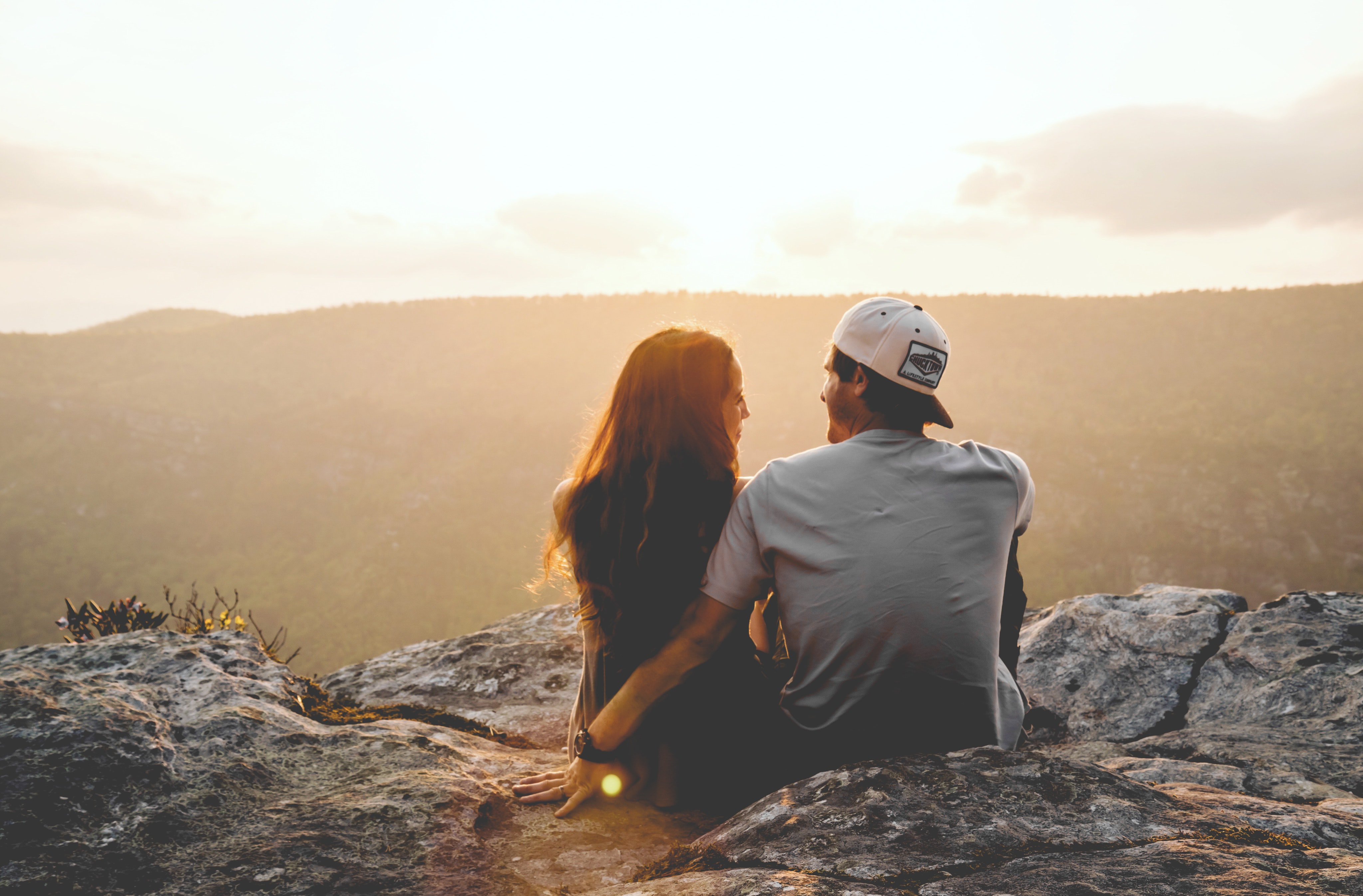 A couple watches the sunset.