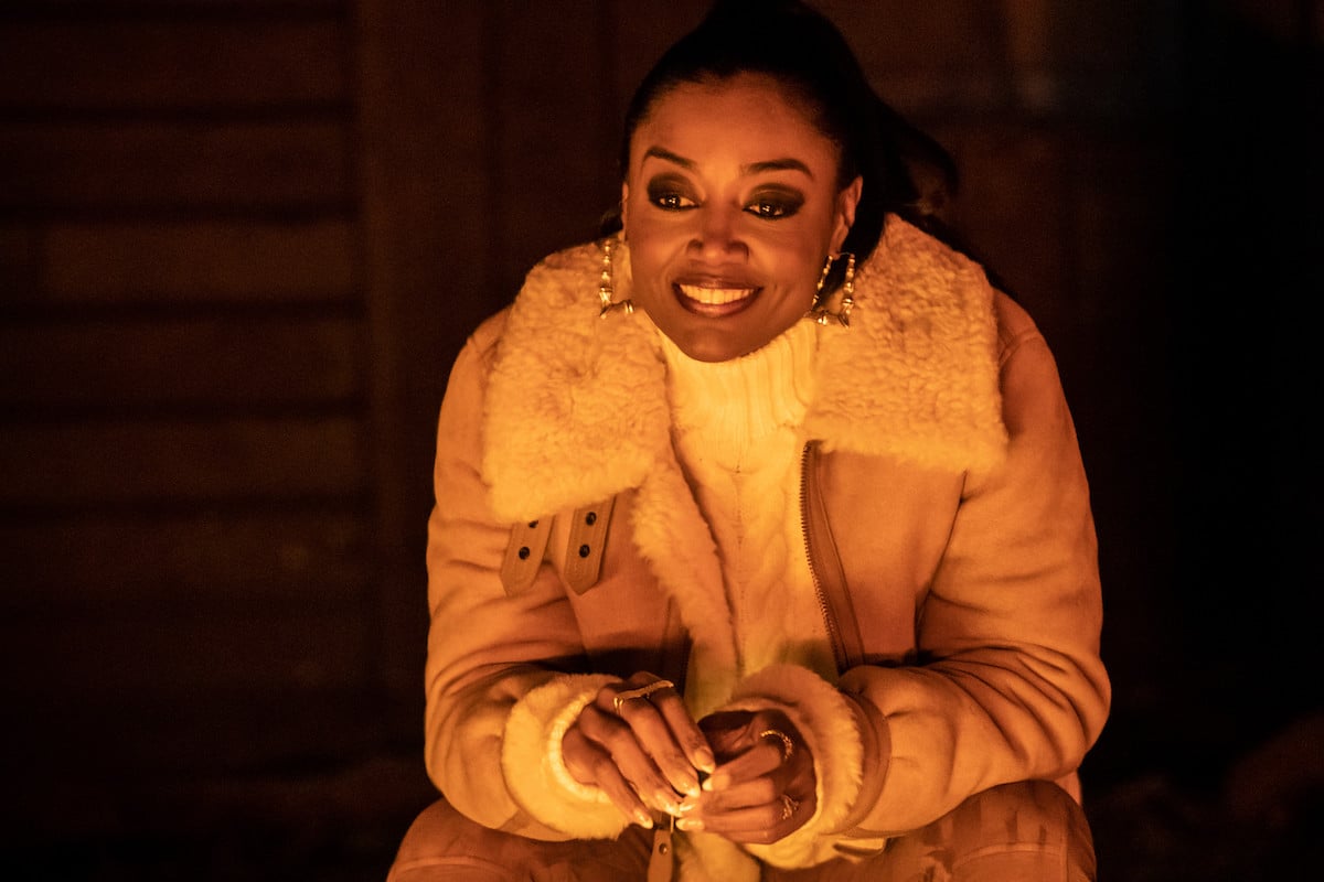 Patina Miller as Raq Thomas sitting by a camp fire in 'Power Book III: Raising Kanan'