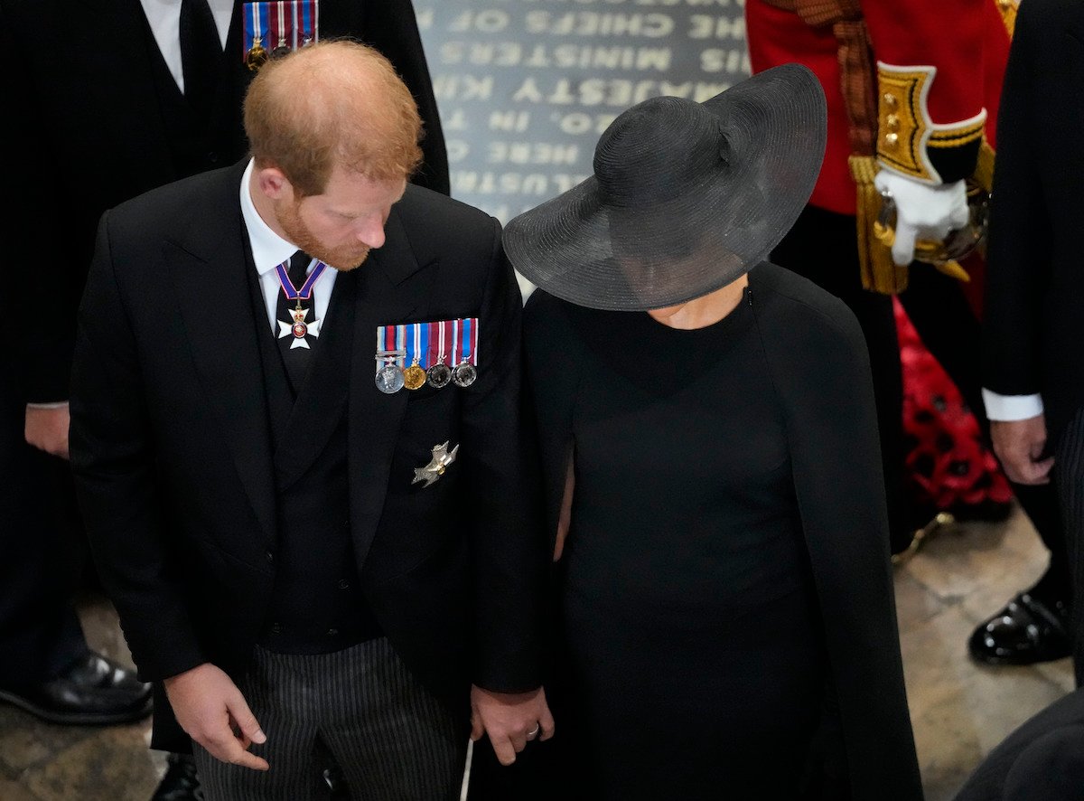 Prince Harry, who had a particularly difficult time at Queen Elizabeth's funeral as the coffin was moved, according to a body language expert, exits Queen Elizabeth's funeral with Meghan Markle